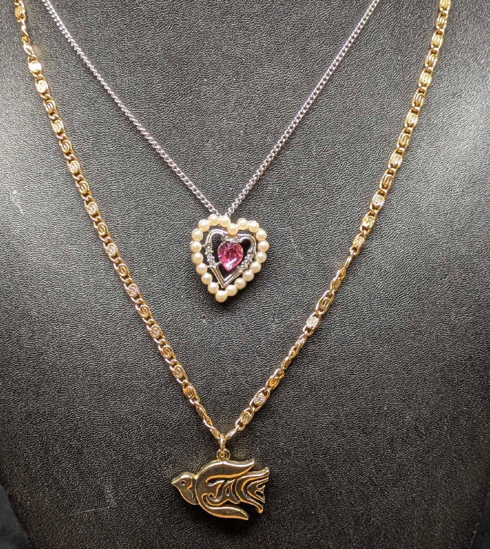 Vinage Avon Triple Heart And Peace Dove Necklaces: Vinage Avon Triple Heart And Peace Dove Necklaces. This lot includes: (1) Avon Triple Heart Rhinestone and Faux Pearl Necklace With Silver Tone Chain. The chain is approx 18". The pendant is
