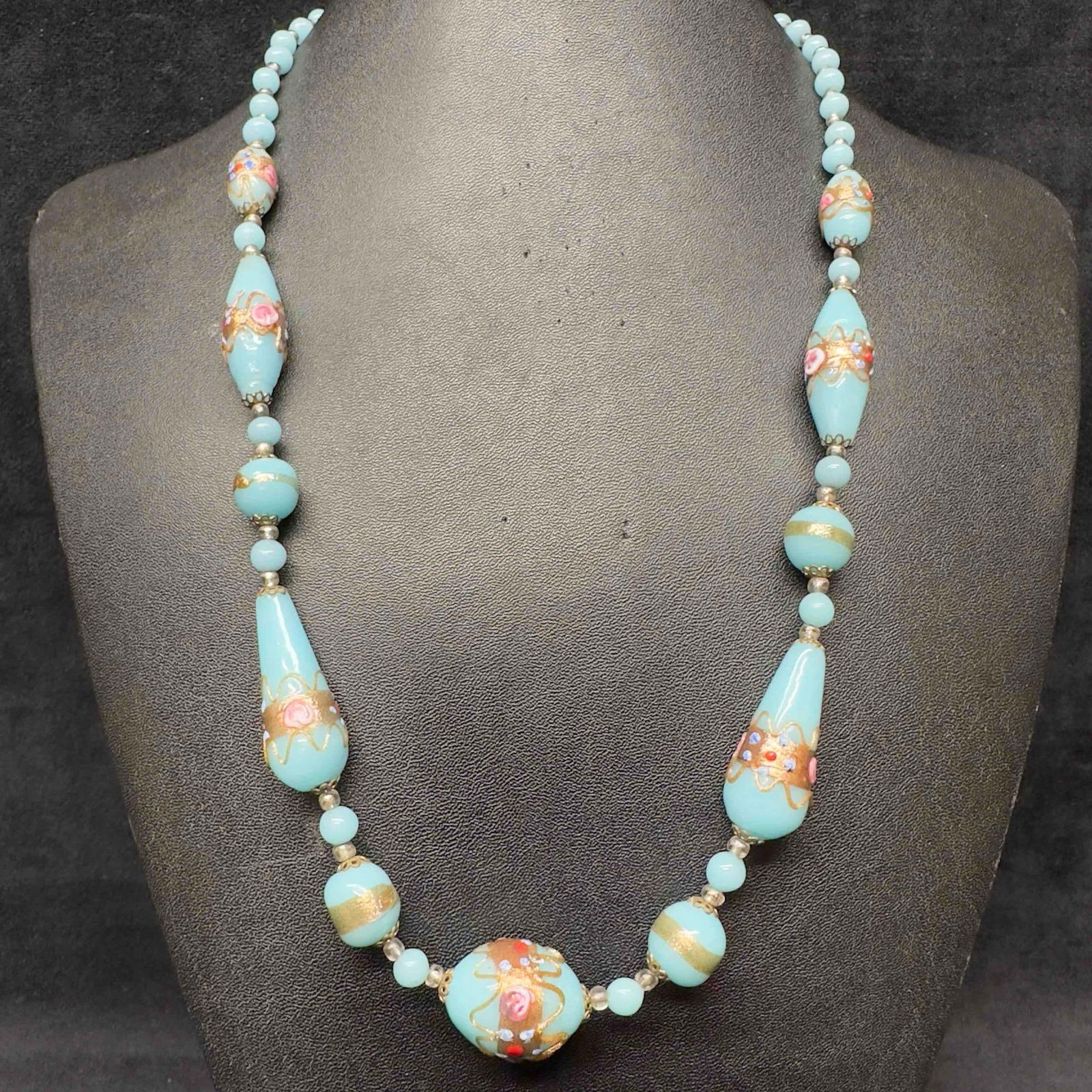 Murano Venetian Lamp Work Art Glass Light Blue Copper Colored Floral Pink Beaded Necklace F50: Murano Venetian Lamp Work Art Glass Light Blue Copper Colored Floral Pink Beaded Necklace F50. Necklace with light blue colored glass beads with a beautiful design on each. The necklace features pink
