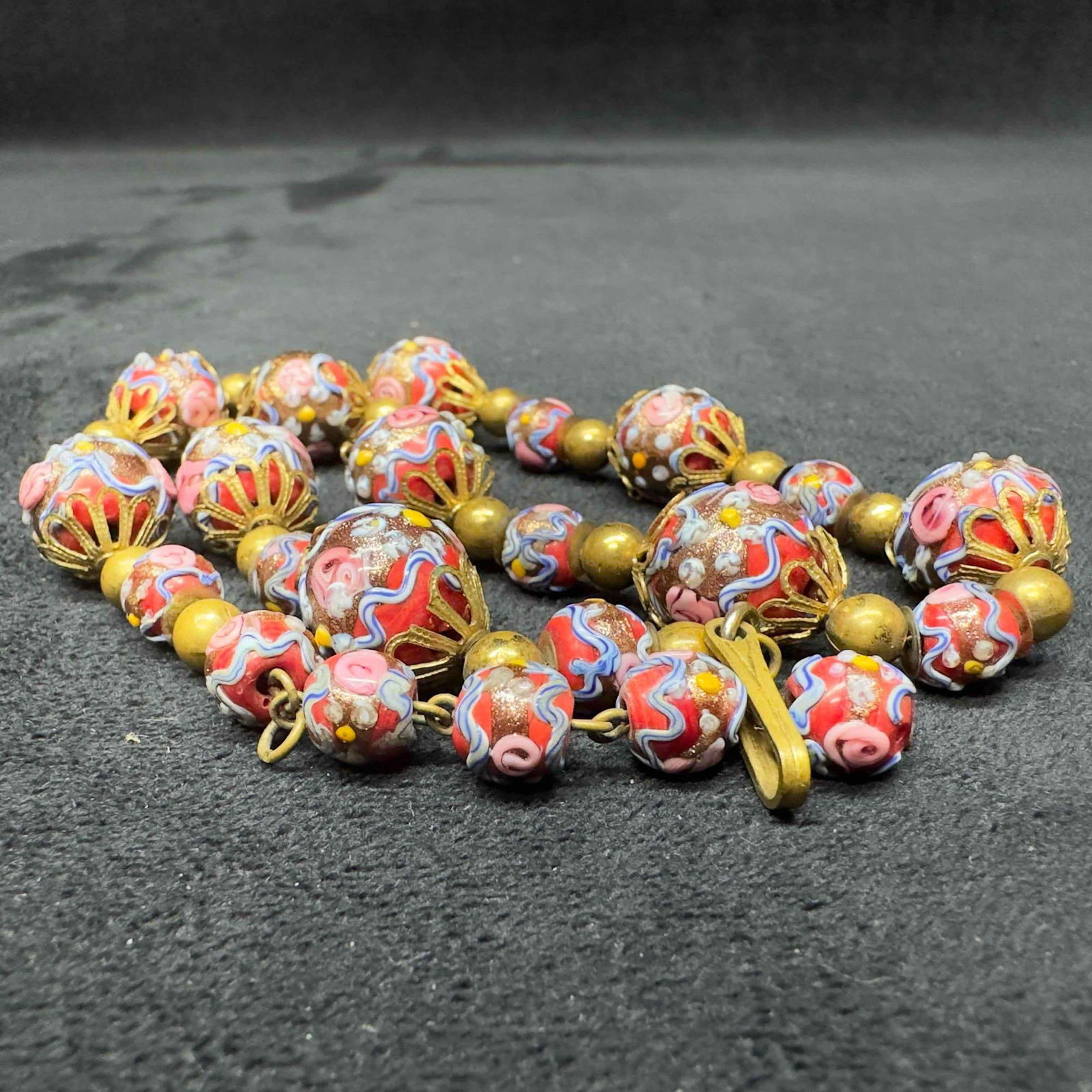 Venetian Murano Lamp Work Art Glass Bead Red Beaded Blue and Gold Accents Necklace B91: Venetian Murano Lamp Work Art Glass Bead Red Beaded Blue and Gold Accents Necklace B91. Necklace with red colored glass beads with beautiful hand painted designs on each. The necklace features blue an