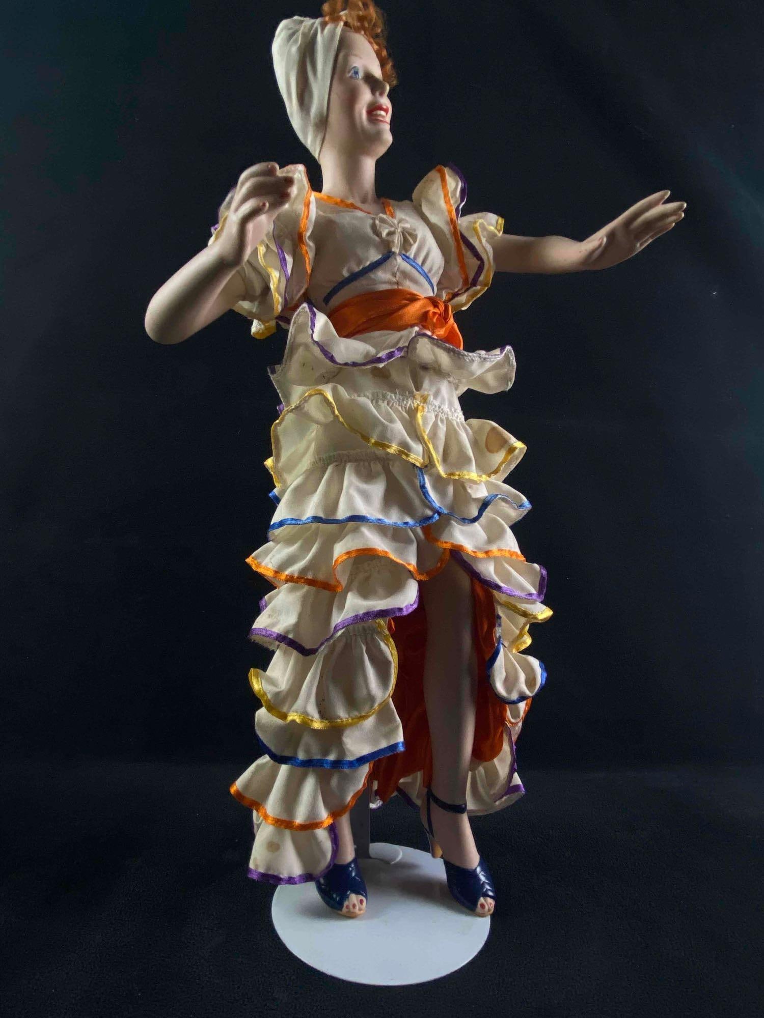 The Hamilton Collection 1996 Lucy Porcelain Doll Carmen Miranda: The Hamilton Collection 1996 Lucy Porcelain Doll Carmen Miranda 1994 Hamilton Serial # 3100A 19" Tall 24 oz Includes white stand Dress has Stains and she is missing her fruit bas