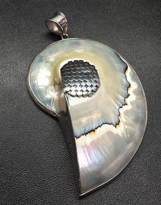 Sterling Mother of Pearl Ammonite-Shaped Pendant: This piece of jewelry has been tested and researched prior to listing. Please view all our pictures they are part of our description. DETAILS: Metal - 925 Sterling Silver Color - Silver Stones - Moth