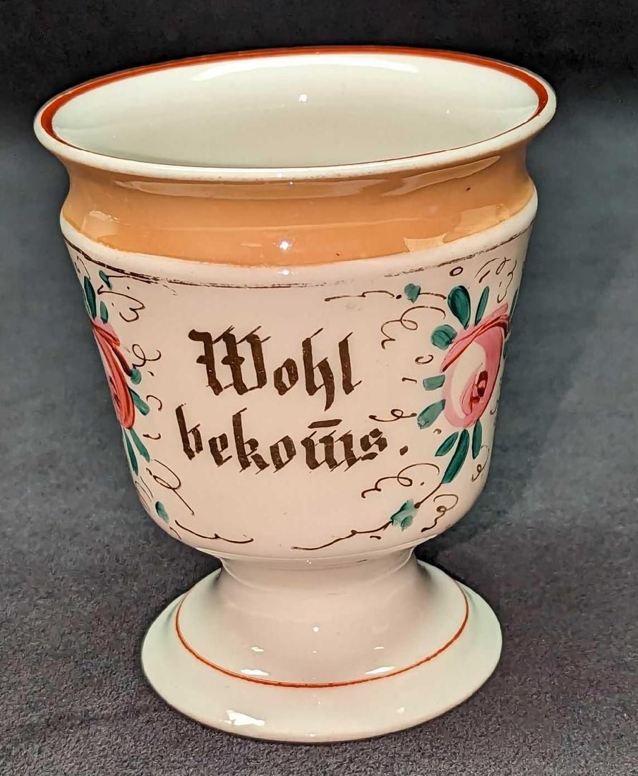 Vintage Porcelain German Cup: Vintage Porcelain German Memory Cup. Has a saying on the side, which roughly translated means, "Well Got". This cup is approx 3 1/4" x 3 1/4" x 4" and it weighs 0.36lb. The cup has some wear on the co