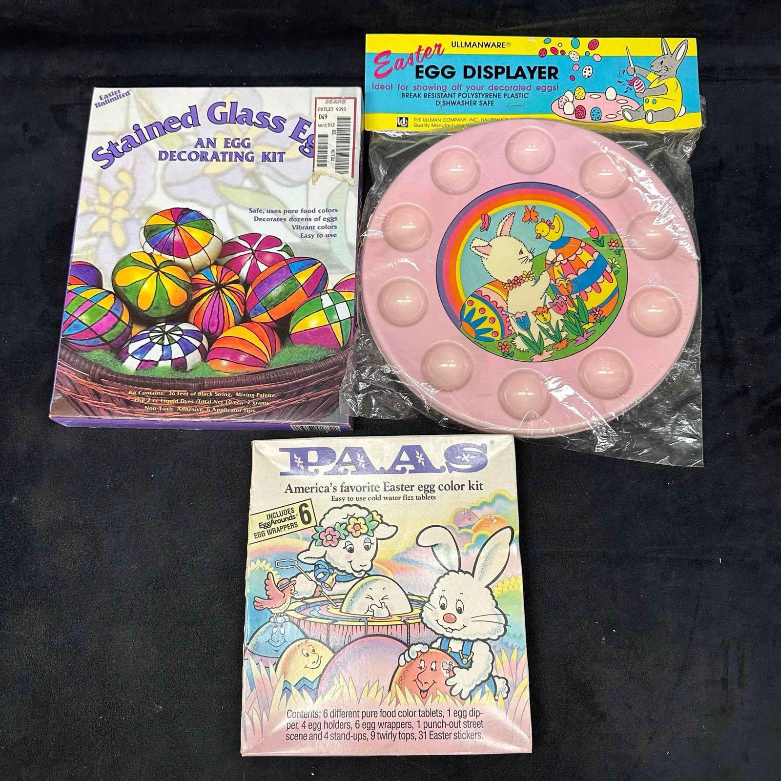 Easter Decorating Lot Stained Glass Eggs Kit Ullmanware Egg Displayer PAAS Egg Color Kit: Group of three vintage Easter decorating items. Includes Stained Glass Eggs decorating kit with dyes, PAAS egg color kit with wrappers and accessories, and Ullmanware plastic Easter egg displayer