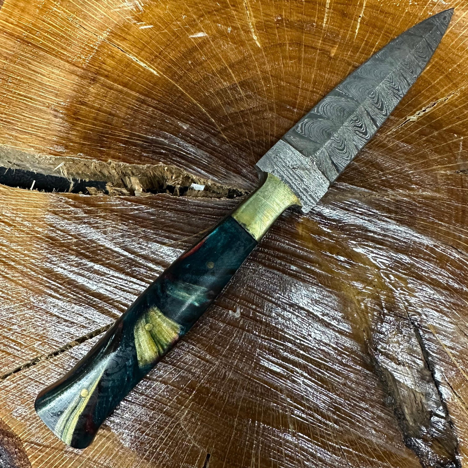 MHS Cutlery Steel Dagger Blade Knife Metallic Hue Handle P58: Fixed dagger-style blade knife by MHS Cutlery featuring a textured steel blade and decorative spine work. The handle has a contoured, multi-colored resin-style grip with metal mosaic pin accents. Incl