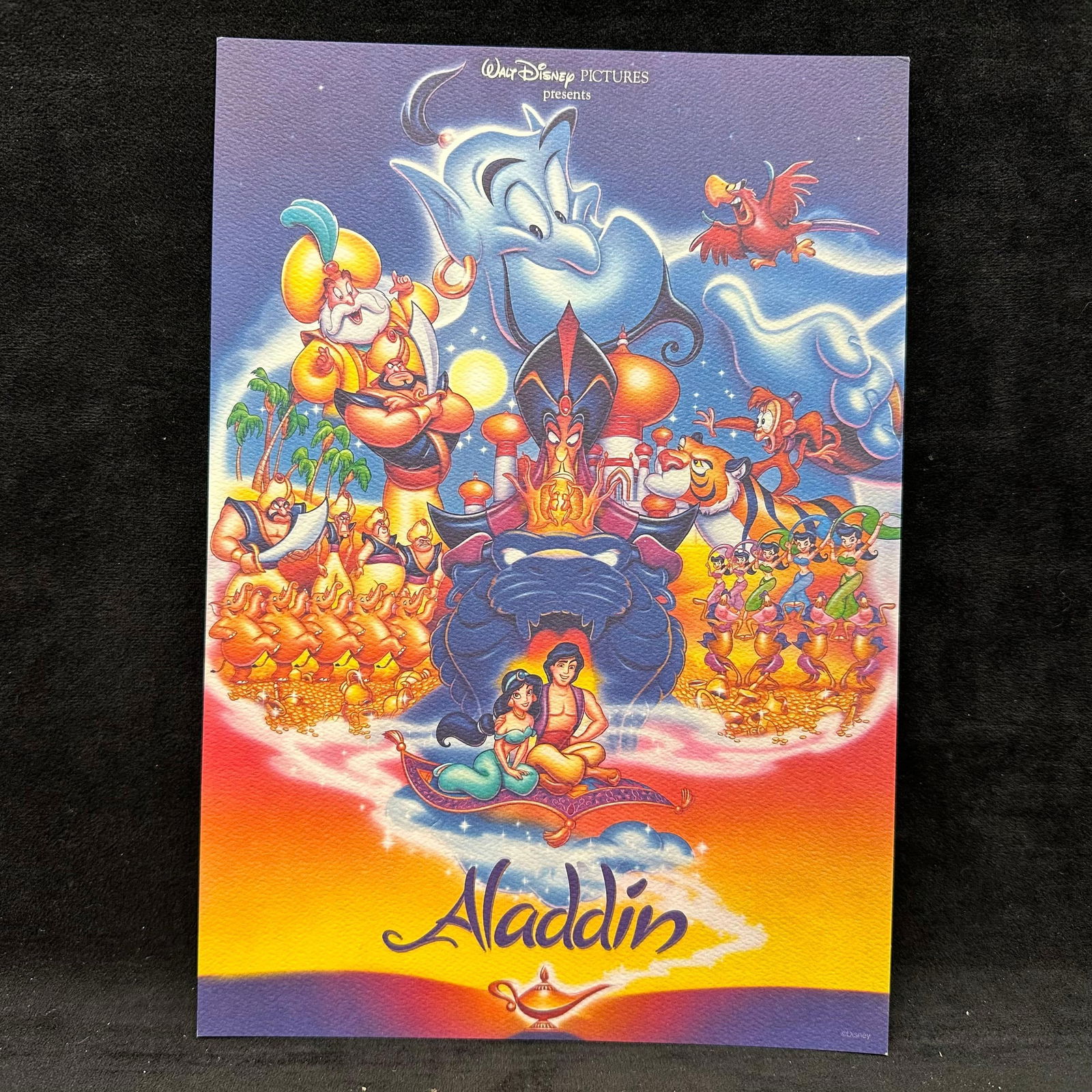 Disney Aladdin Art Print on Textured Paper: Disney art print featuring characters from Aladdin, including Aladdin, Princess Jasmine, Genie, Jafar, Abu, Iago, and supporting characters. Printed on heavyweight, textured art paper with vibrant col
