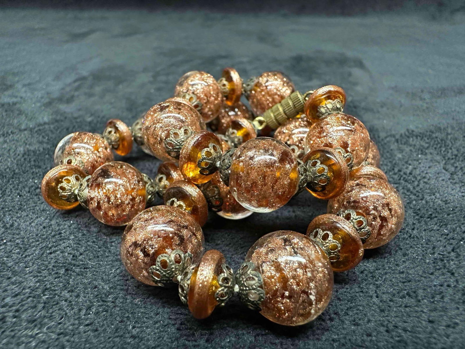 Murano Venetian Lamp Work Art Glass Clear Bead Copper Round Beaded Necklace G48: Murano Venetian Lamp Work Art Glass Clear Bead Copper Round Beaded Necklace G48. Necklace with clear copper colored glass beads with beautiful designs on each. The necklace features copper accents. Th