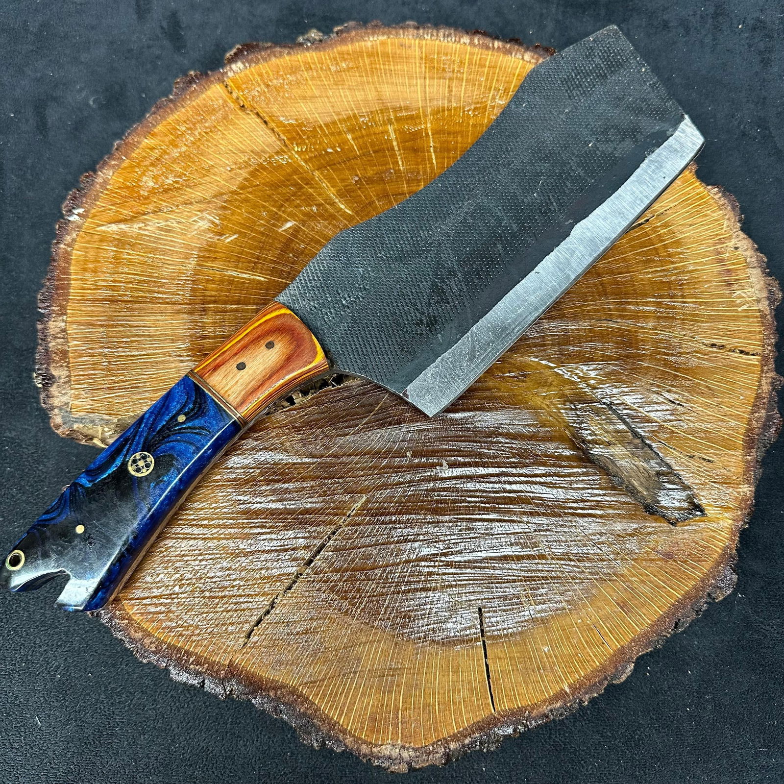 MHS Cutlery Cleaver Knife with Textured Blade Decorative Handle and Leather Sheath: Handcrafted MHS Cutlery fixed-blade cleaver knife featuring a textured steel blade and a multi-material handle with layered wood and resin style accents. Includes fitted brown leather sheath with