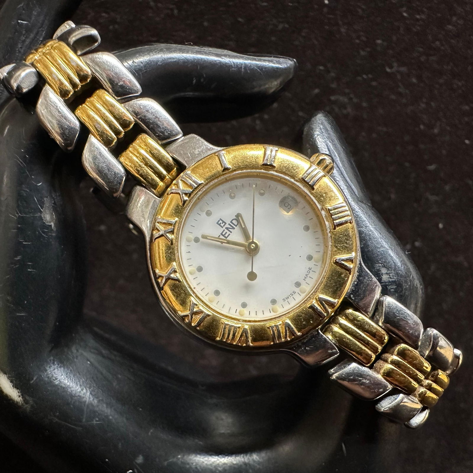 Fendi Orologi 900L Silver and Gold Two Tone Quartz Watch: Has not been tested. Needs a battery; not currently working. This item is in pre-owned, previously displayed condition with light wear and surface markings. Please reference all photos for full detail