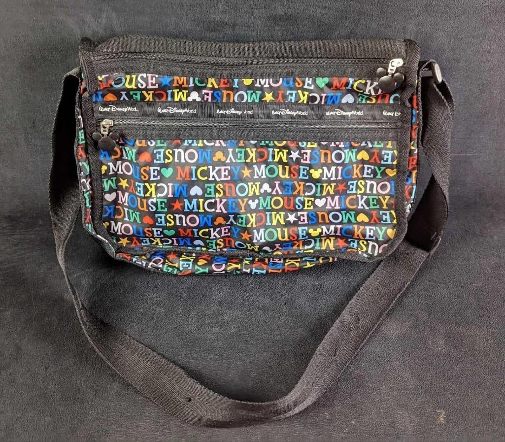 Disney World Mickey Mouse Nylon Book Bag: Disney World Mickey Mouse Nylon Book Bag. Has cute little Mickey Mouse zippers. Is approx 15" x 2" x 10" and it weighs 0.75lb. Has some light wear on the Walt Disney World logo. Please see the images