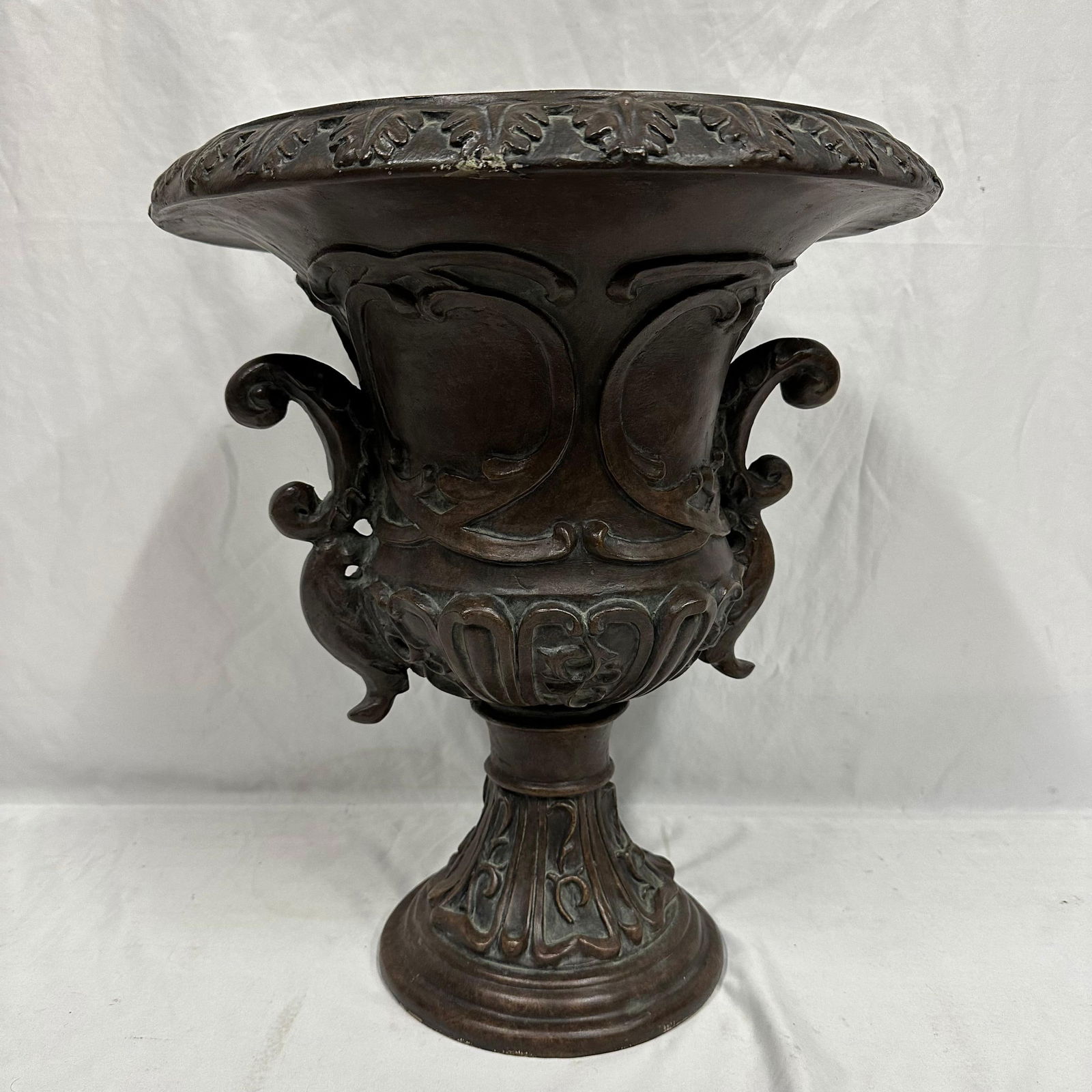 Resin Plaster Type Victorian or Neoclassical Style Outdoor Planter Garden Urn: This outdoor planter garden urn has a flared, deep bowl and pedestal base. Featuring a bronze-toned finish, it is made of a resin plaster-type material. This item is in pre-owned, previously displayed