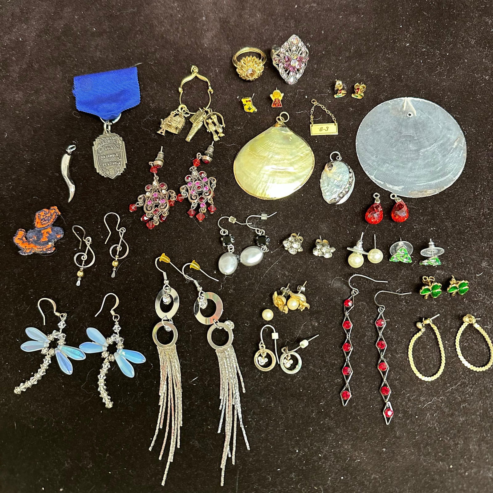 Costume Jewelry Lot Pendants Earrings Rings and Mixed Accessories: Assorted costume jewelry collection featuring an eclectic mix of earrings, pendants, rings, a medal, and fashion accessories. The lot includes multi-design vintage-inspired costume pieces, earrings, a
