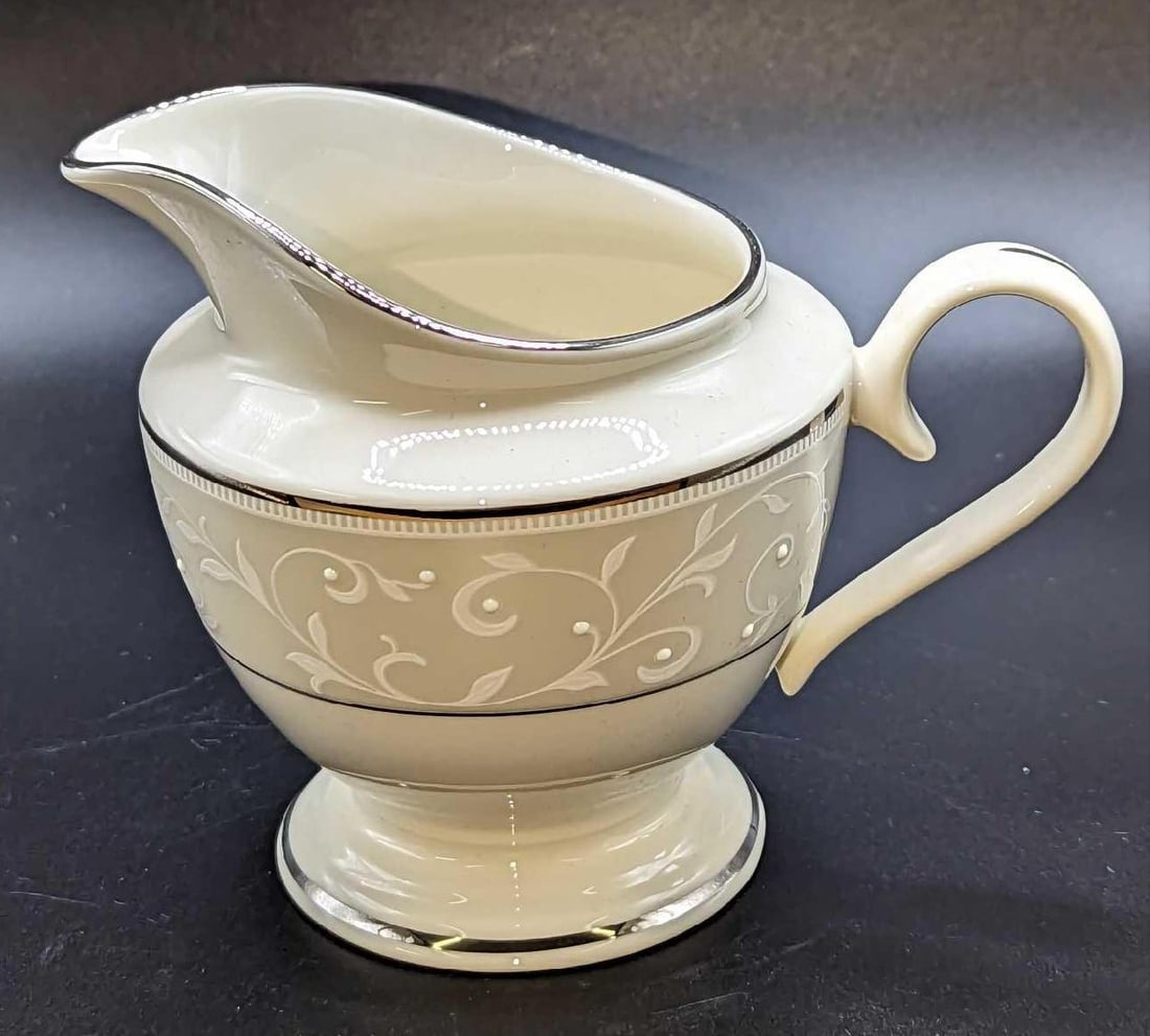 Lenox China Opal Innocence Creamer: Lenox China Opal Innocence Creamer. The creamer is approximately 5" x 3" x 4". It comes in its original box that is approx 6 1/4" x 6 1/4" x 5 5/8" and it weighs 0.82lb. The box has some shelf we