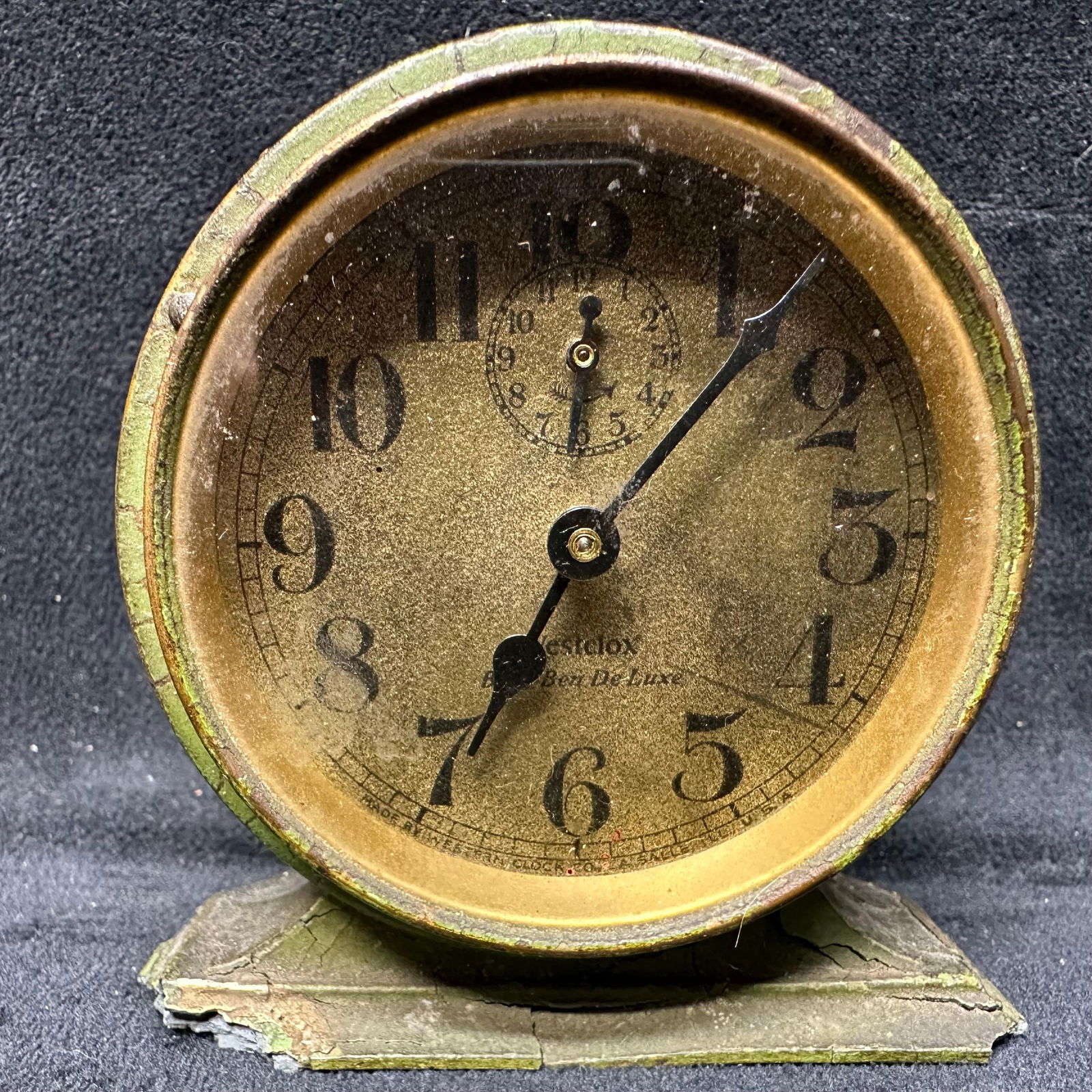Westclox Baby Ben De Luxe Wind Up Alarm Clock: Vintage metal wind-up alarm clock by Westclox, marked Baby Ben De Luxe on the dial. Features a round metal case with aged green paint, raised numerals, and original hands. Clock winds and runs; alarm