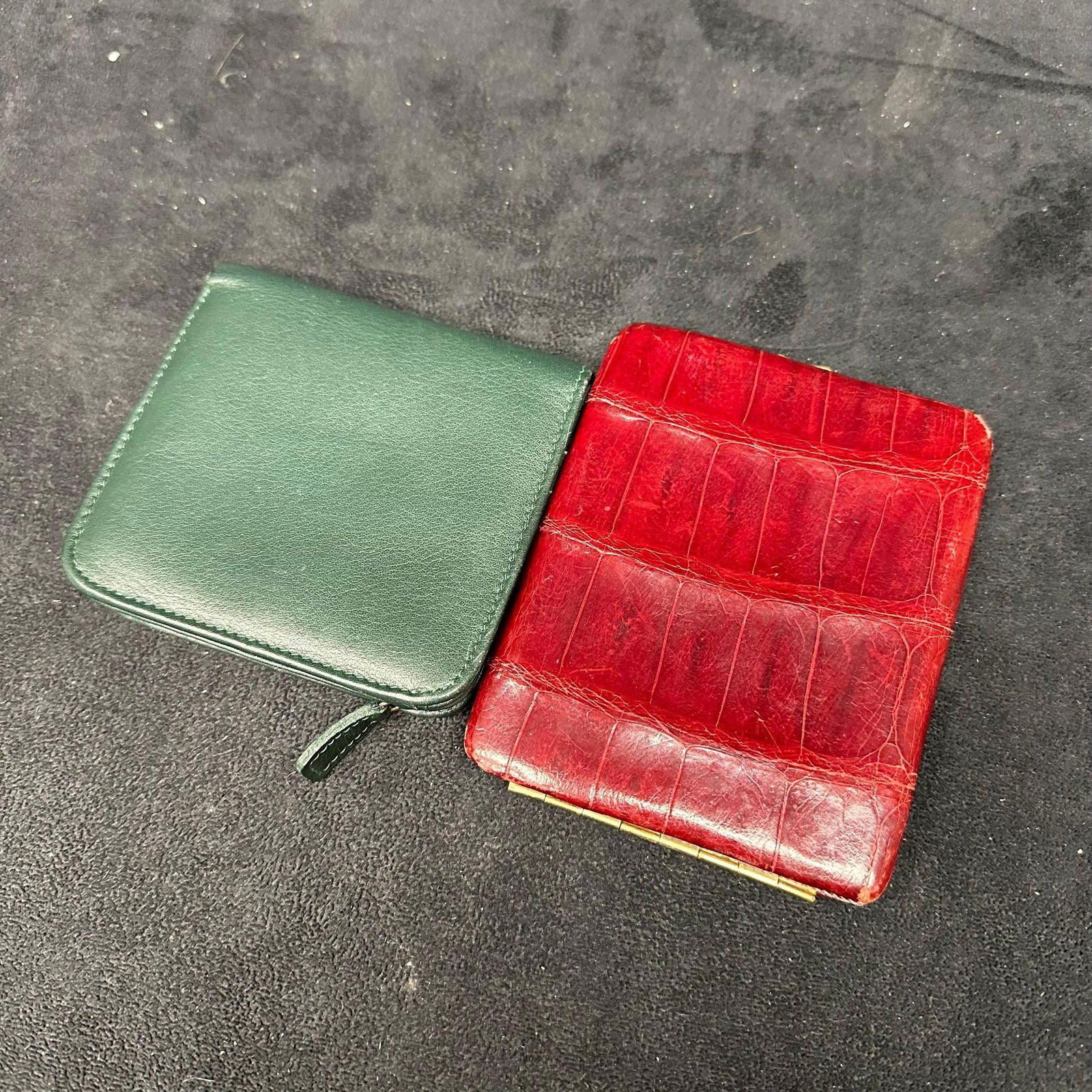 Two Vintage Leather Wallets Green Zip Wallet and Red Crocodile Style: The lot includes two vintage wallets. One is a green leather zip-around wallet with multiple card slots and an ID window, marked Lisa Loren. The second is a red faux crocodile-style leather coin or co