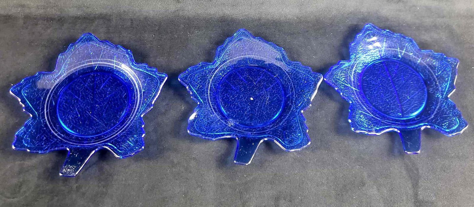 3 Blue Glass LE Smith Glass Co Leaf Shaped Salad Plates: 3 Blue Glass LE Smith Glass Co Leaf Shaped Salad Plates. These plates are in great used condition. There are no chips or cracks in the glass. The plates are made from a deep blue glass and the backs