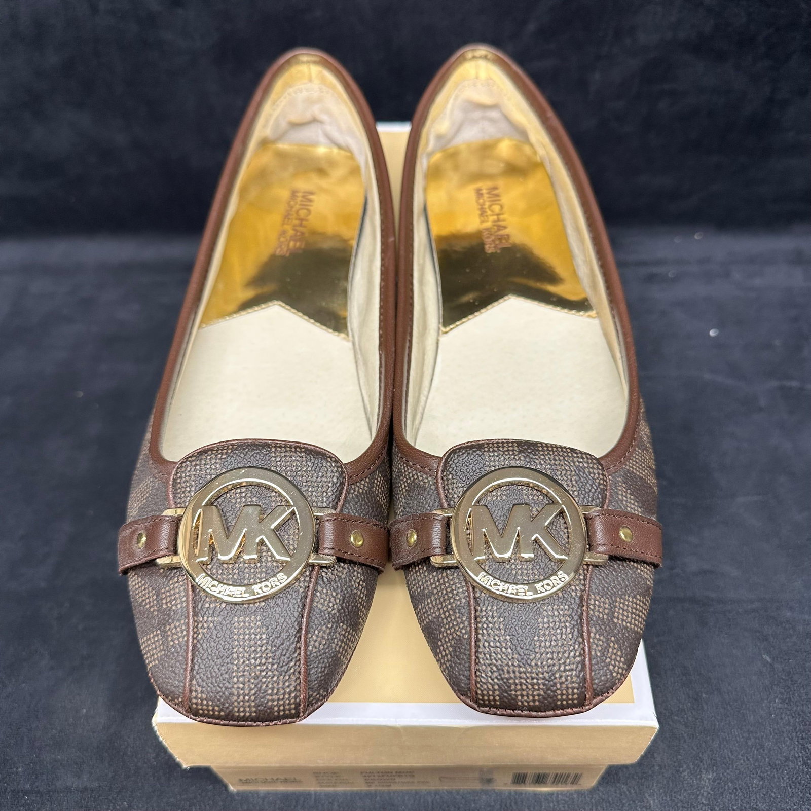 Michael Kors Fulton Moc Flats Brown MK Signature Logo Size 9.5M: Classic pair of Michael Kors “Fulton Moc” flats in brown MK Signature PVC with gold-tone logo hardware across the toe. Features the iconic MK monogram pattern, cushioned insoles, and driving-s