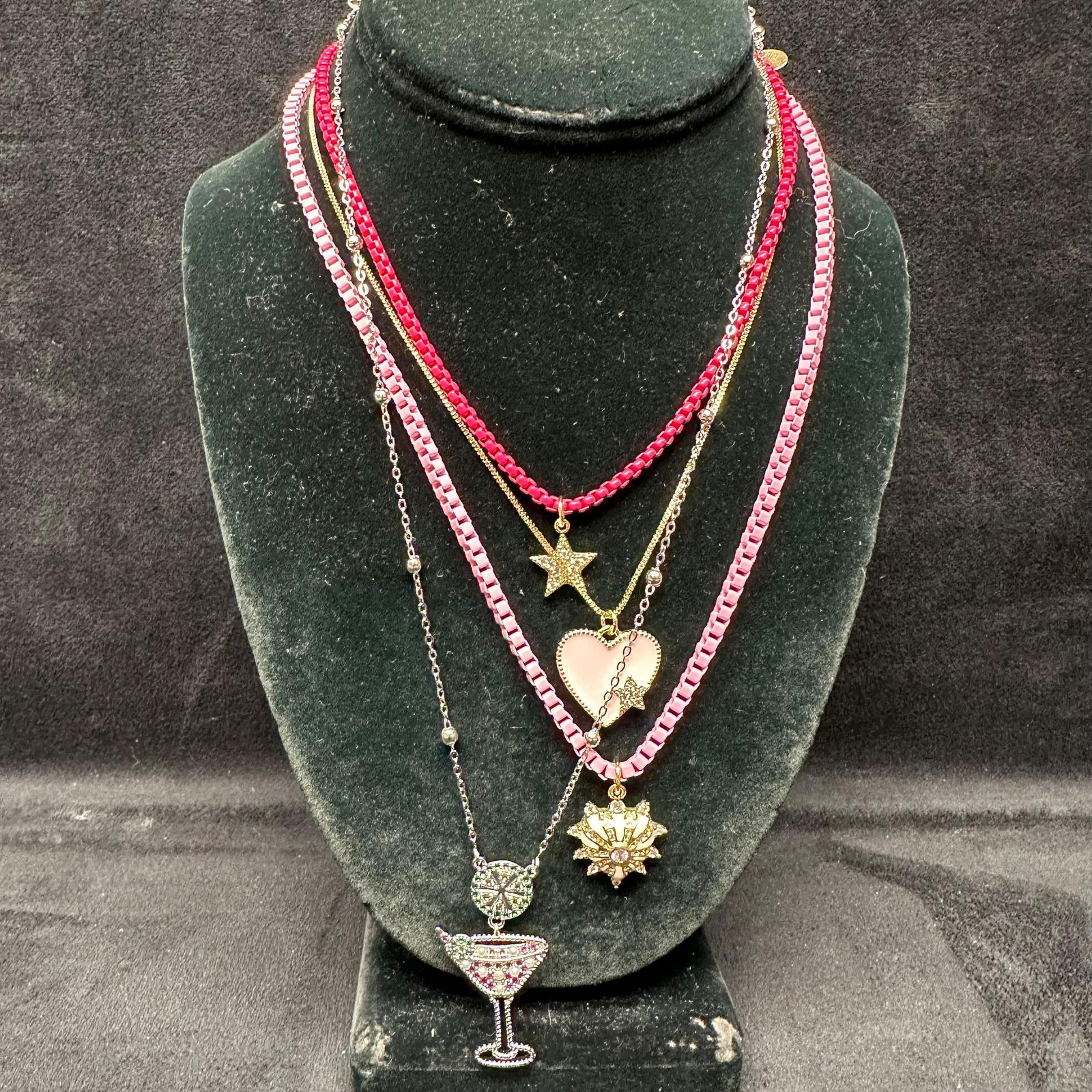 Melania Clara Assorted Necklace Set Martini Heart Star Motifs L98: The Melania Clara and Alexa Rae necklace set features a magnet clasp closure. The necklaces have magnet extender clasp closures. Each necklace showcases modernist designs with gold-toned and rhineston