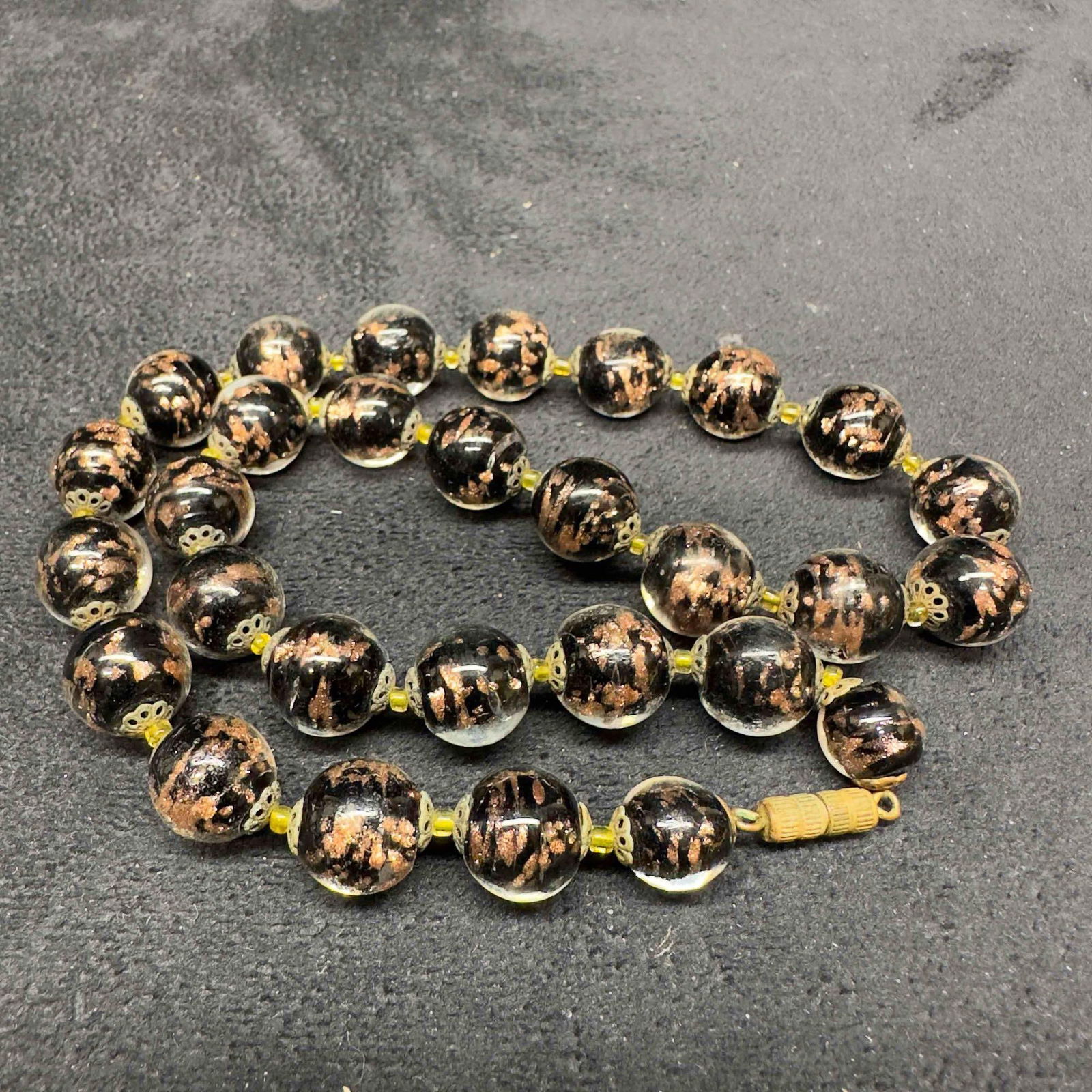 Murano Venetian Lamp Work Glass Copper Black Round Beaded Necklace B32: Murano Venetian Lamp Work Glass Copper Black Round Beaded Necklace B32. Necklace with black colored glass beads with beautiful designs on each. The necklace features copper accents. The necklace