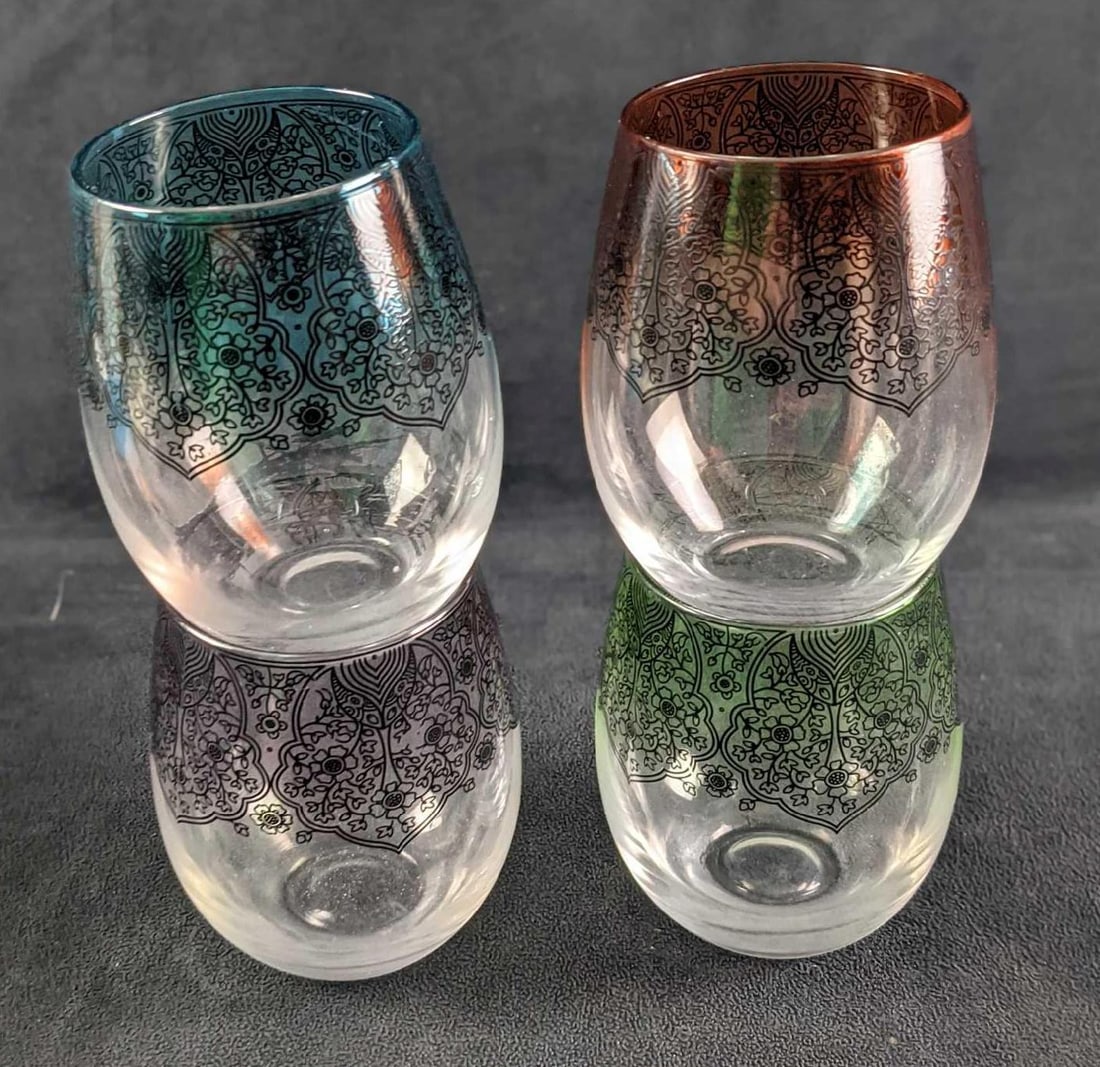 Four Stemless Wine Glasses: Four Stemless Wine Glasses. Each is approx 4" x 4" x5" and together they weigh 1.91lb. The maker and date of creation are unknown. Glasses are in a good, used condition with some of the glasses' coati