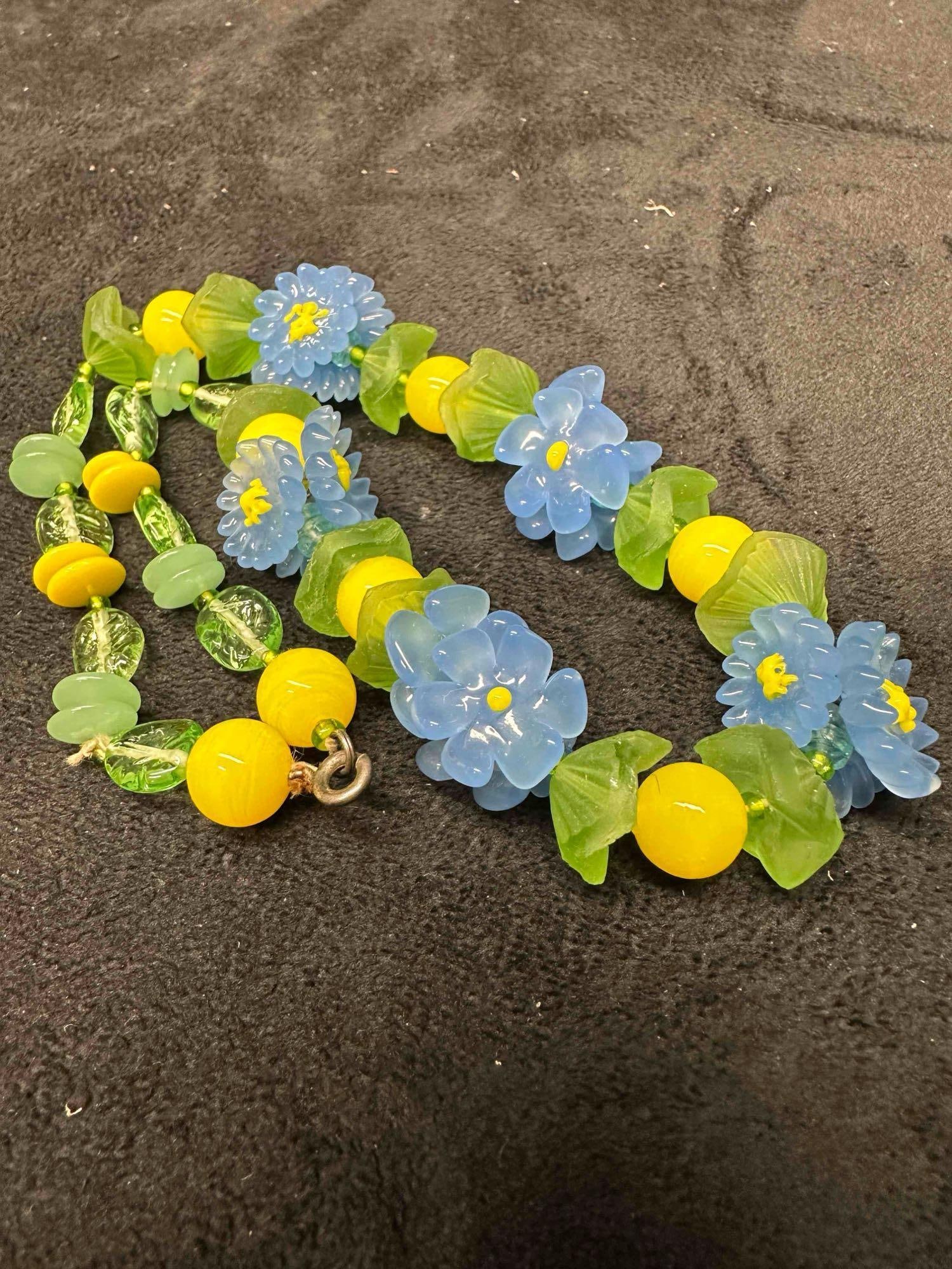 Murano Venetian Lamp Work Glass Blue Flower Bead Beaded Floral Necklace A72: Murano Venetian Lamp Work Glass Blue Flower Bead Beaded Floral Necklace A72. Necklace with blue colored flower shaped glass beads with beautiful designs on each. The necklace features floral accents.