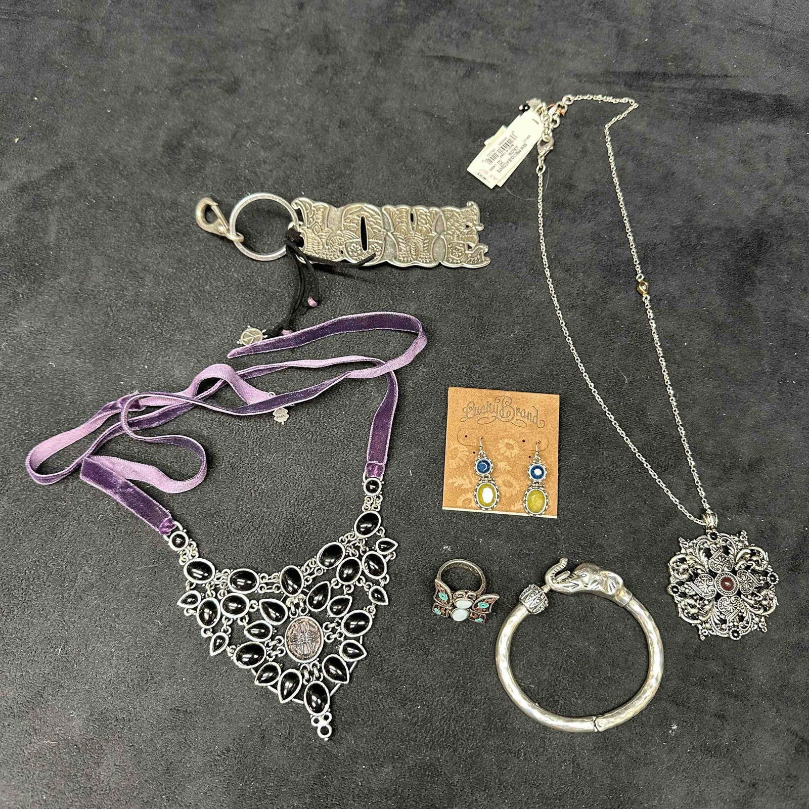 Lucky Brand Costume jewelry Set Keychain Earrings Necklaces Ring: Lucky Brand jewelry set featuring a bracelet, two necklaces, a ring, a pair of earrings, and a key chain. Some of the items are in like new with original tag. These items are in good pre-owned, previo