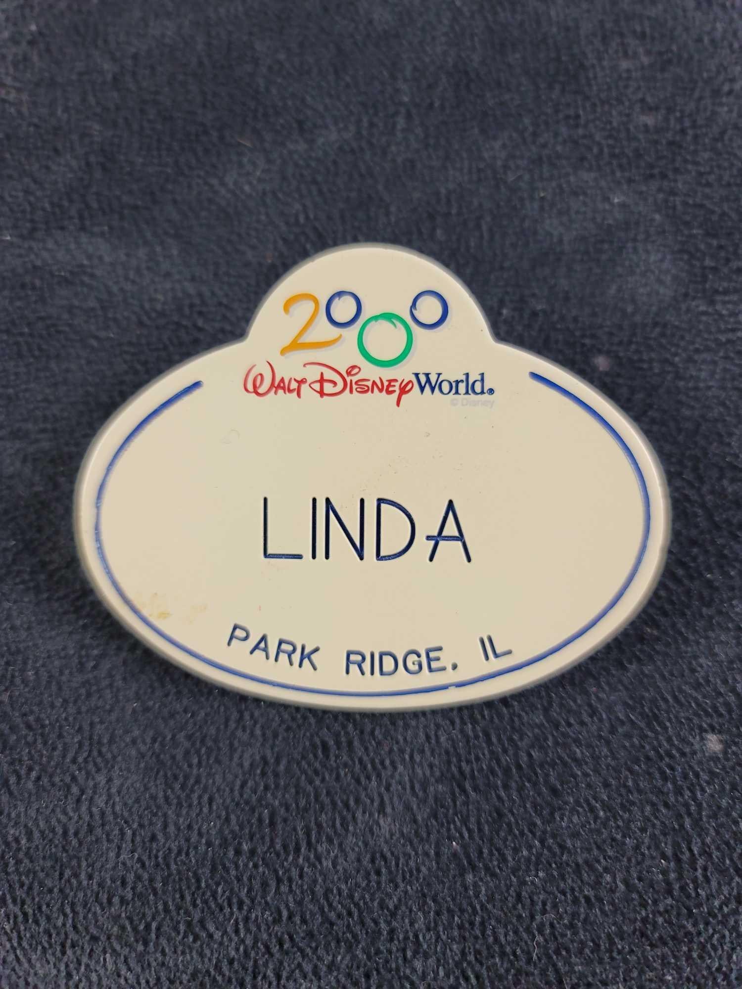Disney Cast Member Name Tag Linda: This name badge is in good condition with some known ware and discoloration, please see photos. The badge is 2000 Linda from Park Ridge, IL. Approx. measures 2 1/2" x 2", weight is .01 lbs. 