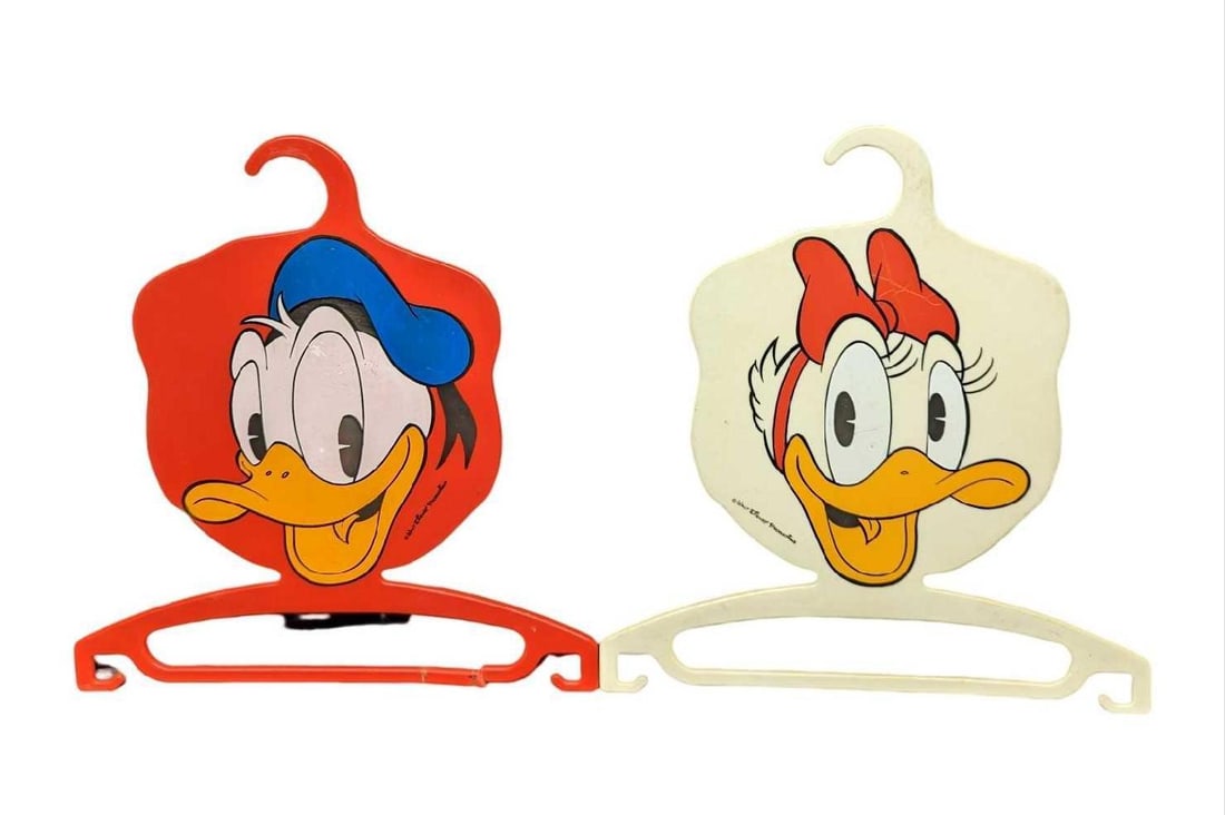Vintage Disney Donald & Daisy Duck Clothes Hangers: Vintage Disney Donald & Daisy Duck Clothes Hangers. Made out of plastic and in Germany. Each hanger is approx 12" x 1/8" x 12 3/4" and together they weigh 0.53lb. The hangers have some signs of wear,