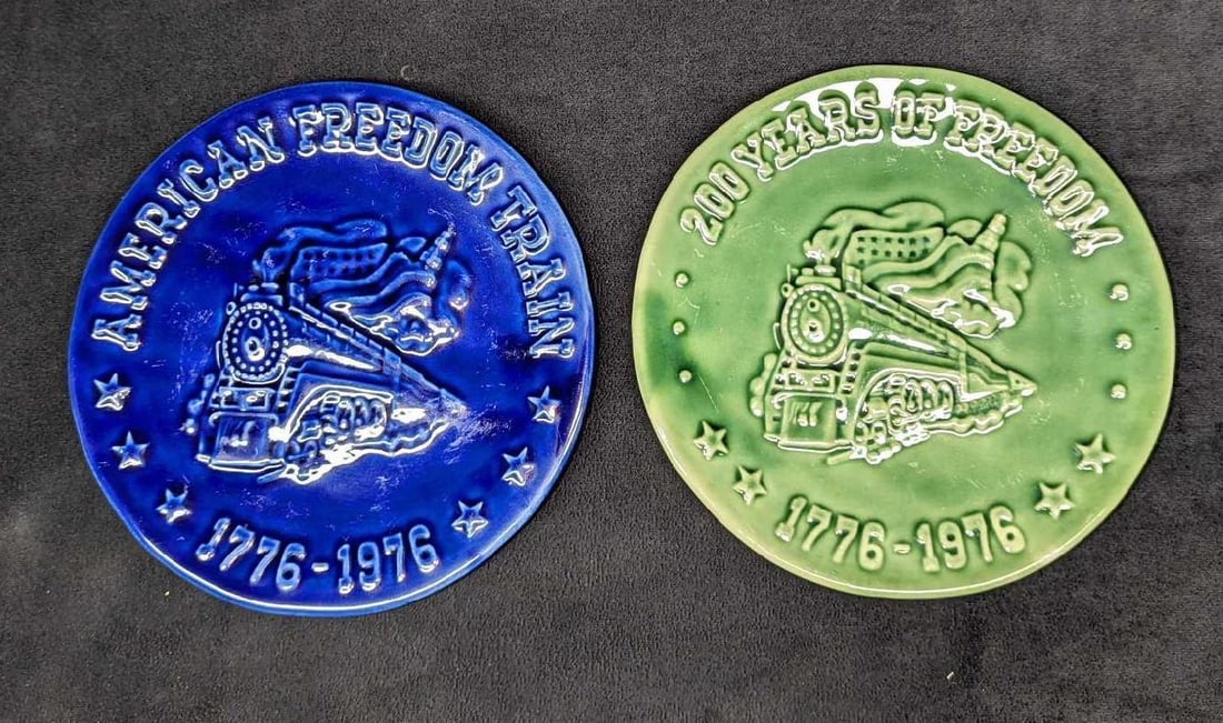 2 Vintage Freedom Train Ceramic Wall Plates: 2 Vintage Freedom Train Ceramic Wall Plates. The green plate is marked, "200 Years Of Freedom - 1776 to 1976" and the purple plate is marked "American Freedom Train 1776 to 1976". Each plate is approx