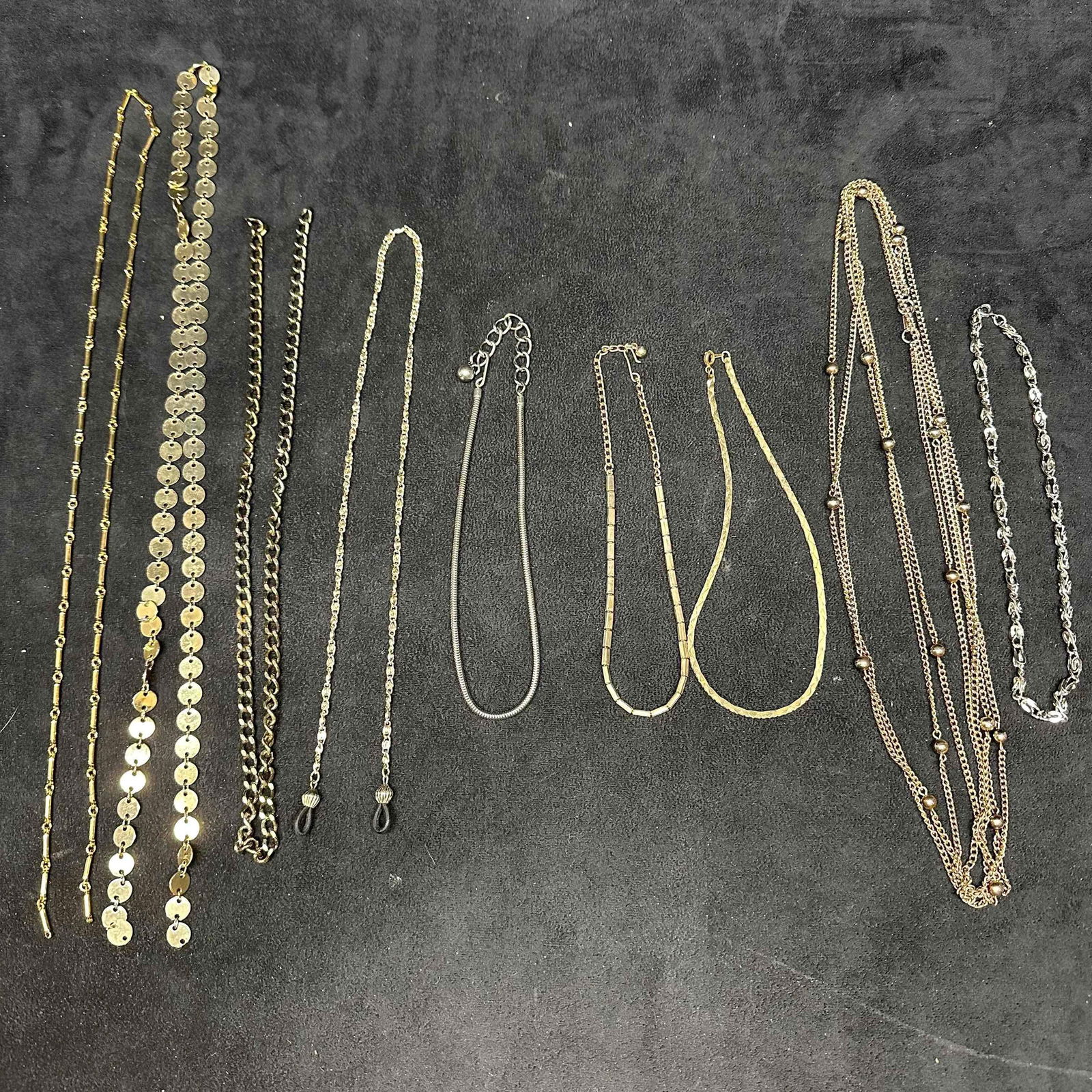 Vintage Mixed Chain Necklace Lot Gold and Silver Tone Fashion Jewelry Set: Lot of nine assorted vintage chain necklaces in gold tone and silver tone finishes. Includes link chains, snake chain, herringbone style, disc link, beaded accents, and multi-strand styles. Good overa