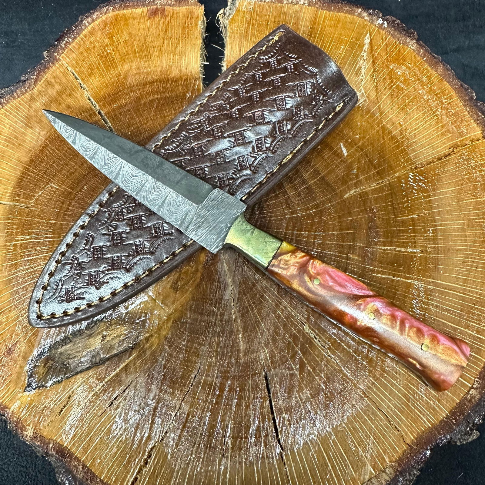 MHS Cutlery Fixed Blade Knife Metallic Orange Pink Colored Handle P39: Fixed dagger-style blade knife by MHS Cutlery featuring a textured steel blade and decorative spine work. The handle has a contoured, metallic orange-pink colored resin-style grip with metal pin