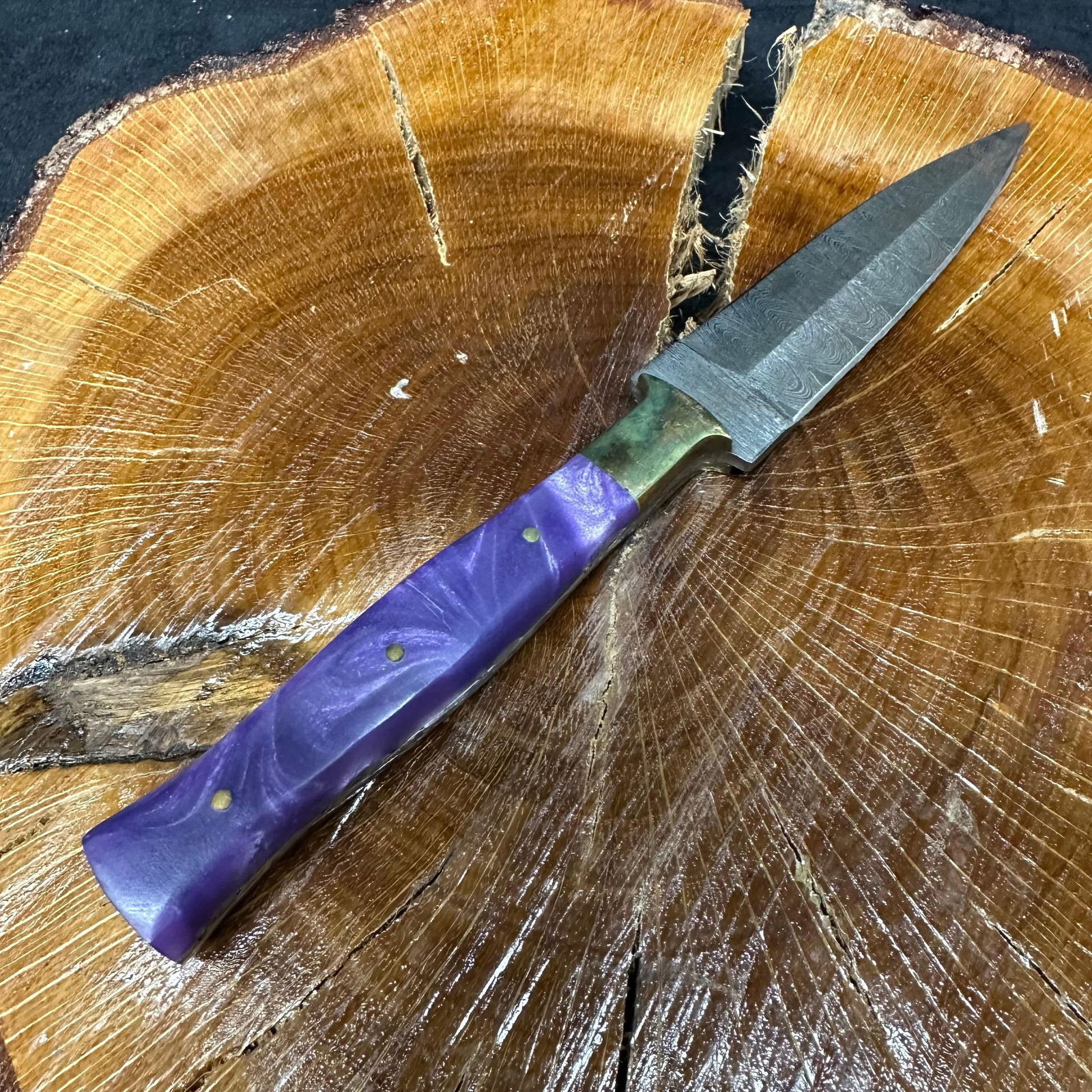Purple Petty Culinary Dagger Style Knife MHS Cutlery P40: Fixed dagger-style blade knife by MHS Cutlery featuring a textured steel blade and decorative spine work. The handle has a contoured, purple-colored resin-style grip with metal mosaic pin accents.