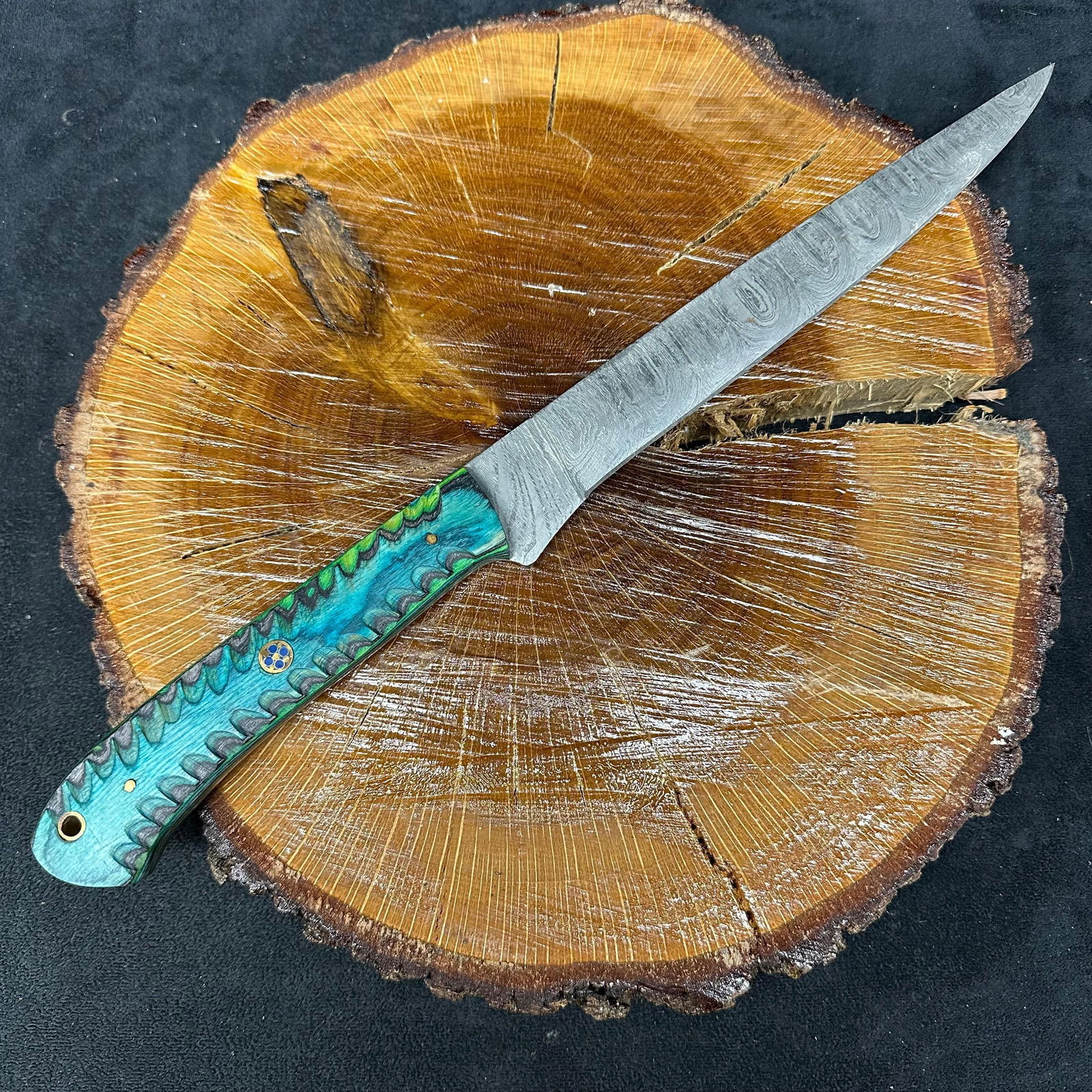 Long MHS Cutlery Aqua Blue Green Handle Fixed Blade Knife P32: Fixed long blade knife by MHS Cutlery featuring a patterned steel blade. The handle is constructed with multi-tone stabilized material in aqua blue/green and gray hues, accented with mosaic pins and a