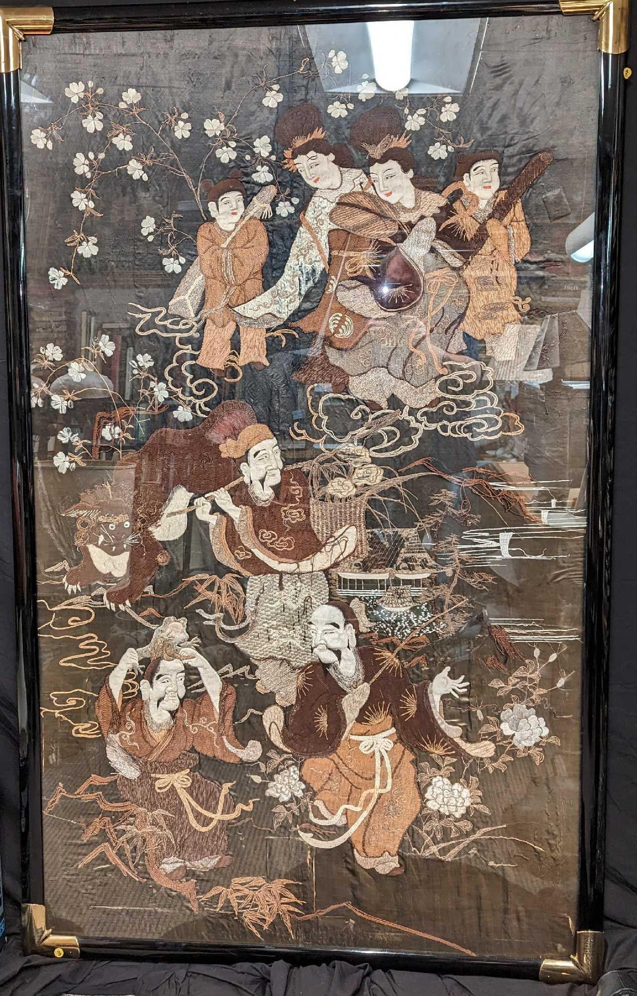 Large Framed Vintage Asian Silk Embroidery Artwork: Large Framed Vintage Asian Silk Embroidery Artwork. Its maker and date of creation are unknown. It appears the man below is telling the man next to him a story about his visit to the Heavens, where he