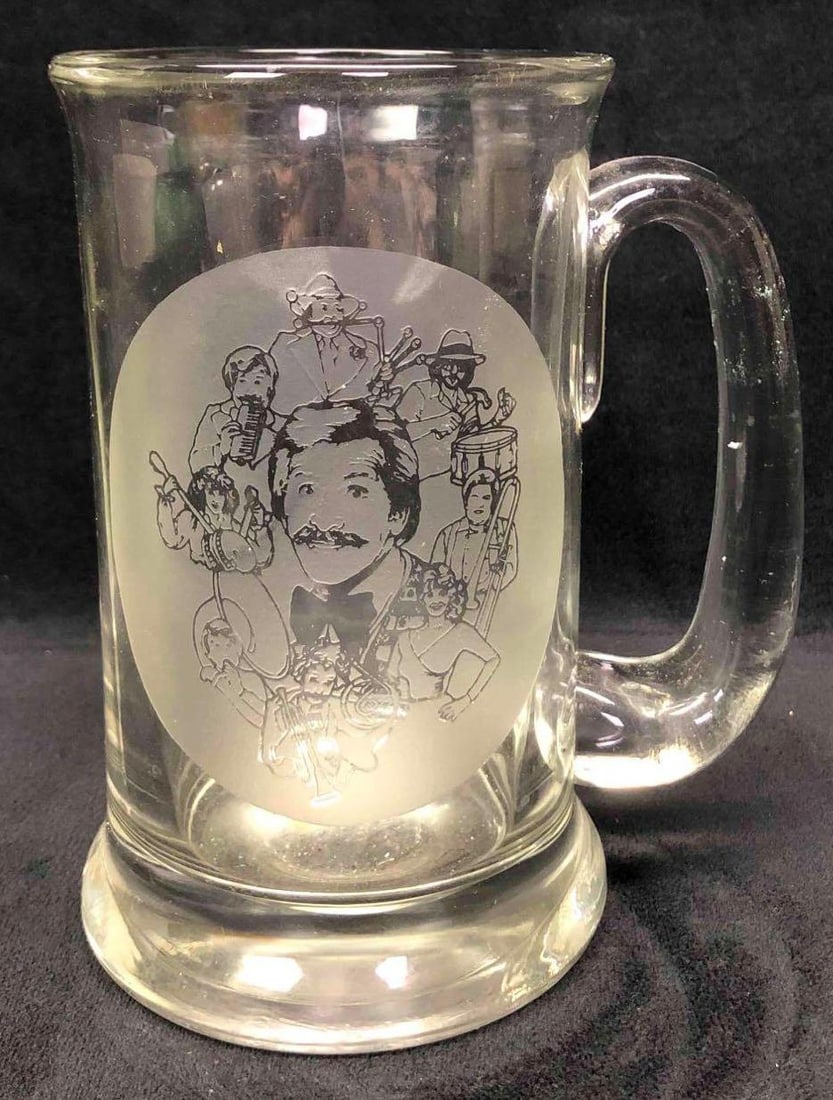 Large Glass Etched Mug With Mickey Finn Show & Cast: This lot conatins a glass mug etched with The Mickey Finn Show cast. It is approx 5" x 3 1/2" x 5 3/4" and weighs about 1.5lbs. The glass mug is in good used condition with some light ware from use