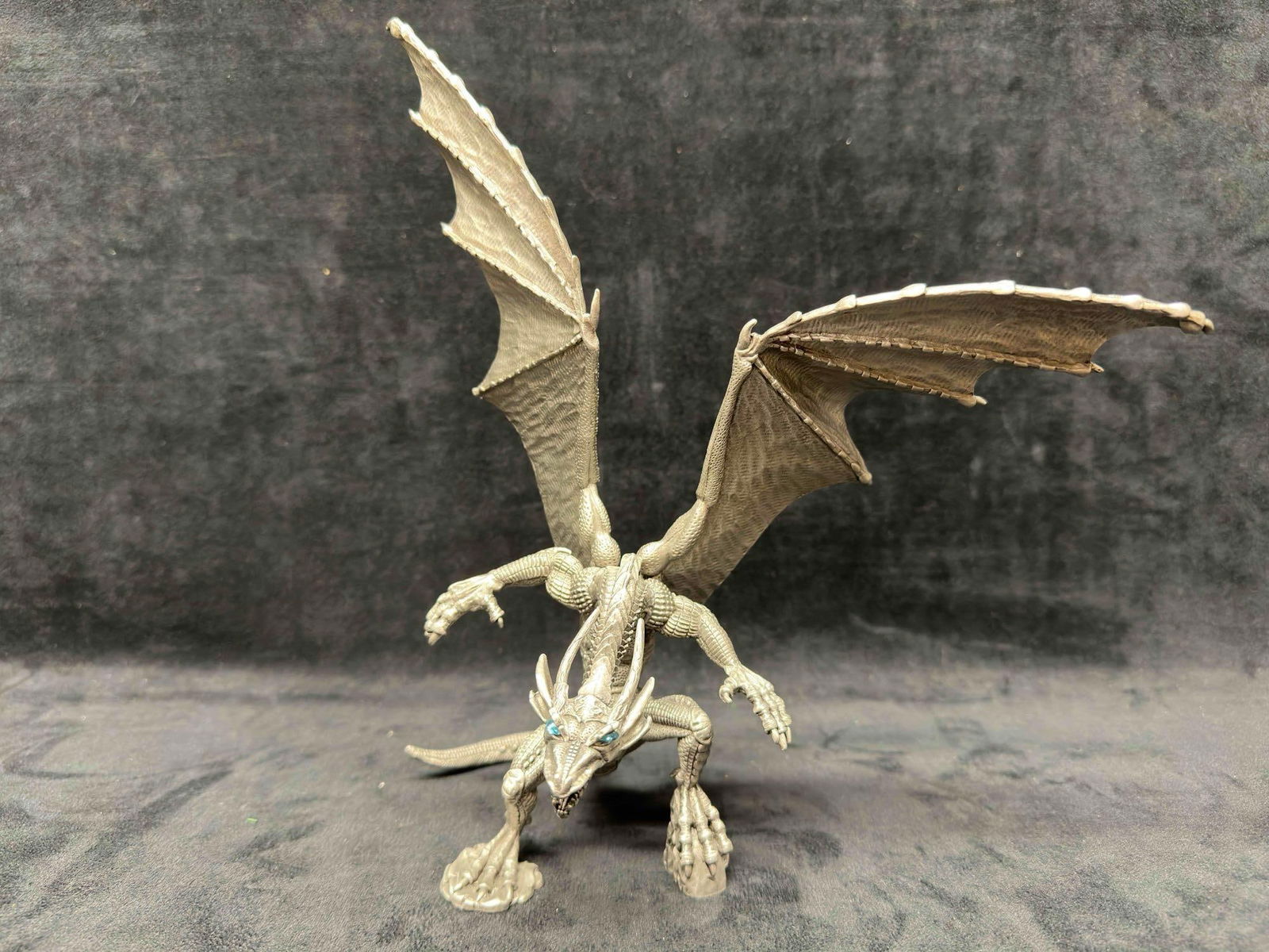 Rawcliffe Pewter Blue Eyed Dragon 1999 Reaper Sculpture Figure 1166030: Rawcliffe Pewter Blue Eyed Dragon 1999 Reaper Sculpture Figure 1166030. Reaper and more Rawcliffe identifying markings etched on the bottom. The figure has blue gem stone accents. This item is in good