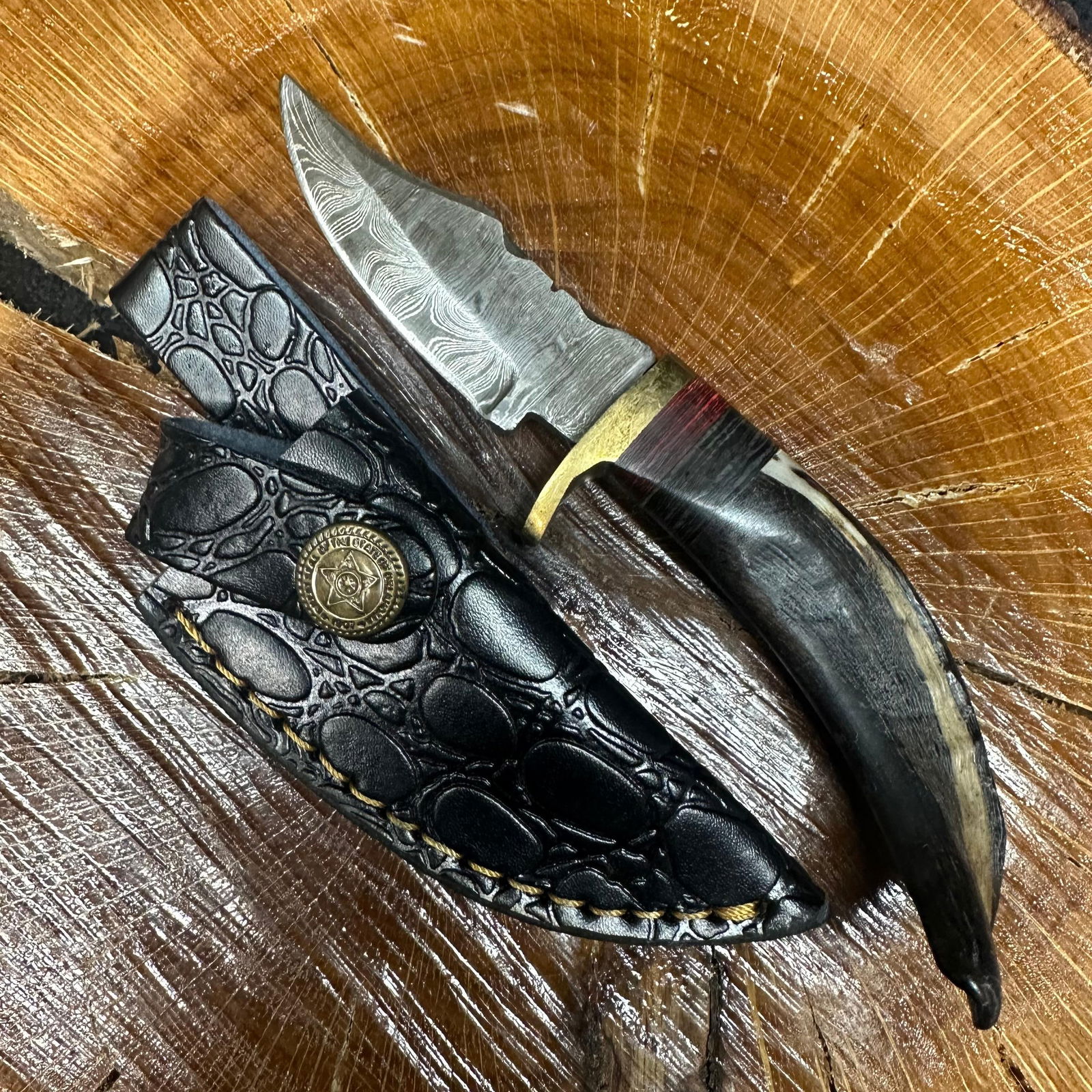 Small Fixed Blade Knife MHS Cutlery Horn Handle R28: Fixed small blade knife by MHS Cutlery featuring a textured steel blade and decorative spine work. The handle has a contoured, horn-style grip with metal mosaic accents. Includes a fitted black