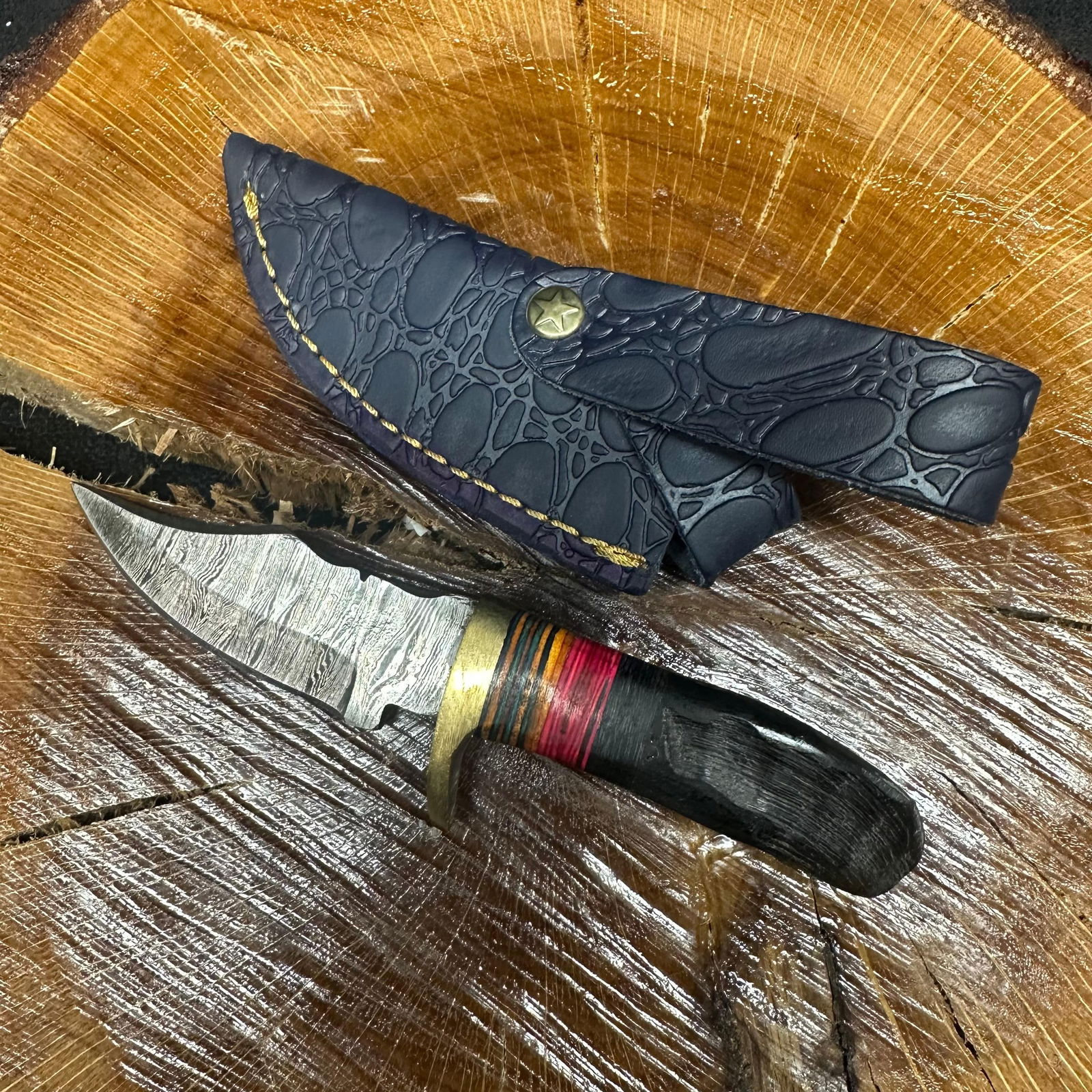 Small Fixed Blade Knife MHS Cutlery Horn Handle with Blue Sheath R30: Fixed small blade knife by MHS Cutlery featuring a textured steel blade and decorative spine work. The handle has a contoured, horn-style grip with metal mosaic accents. Includes a fitted blue