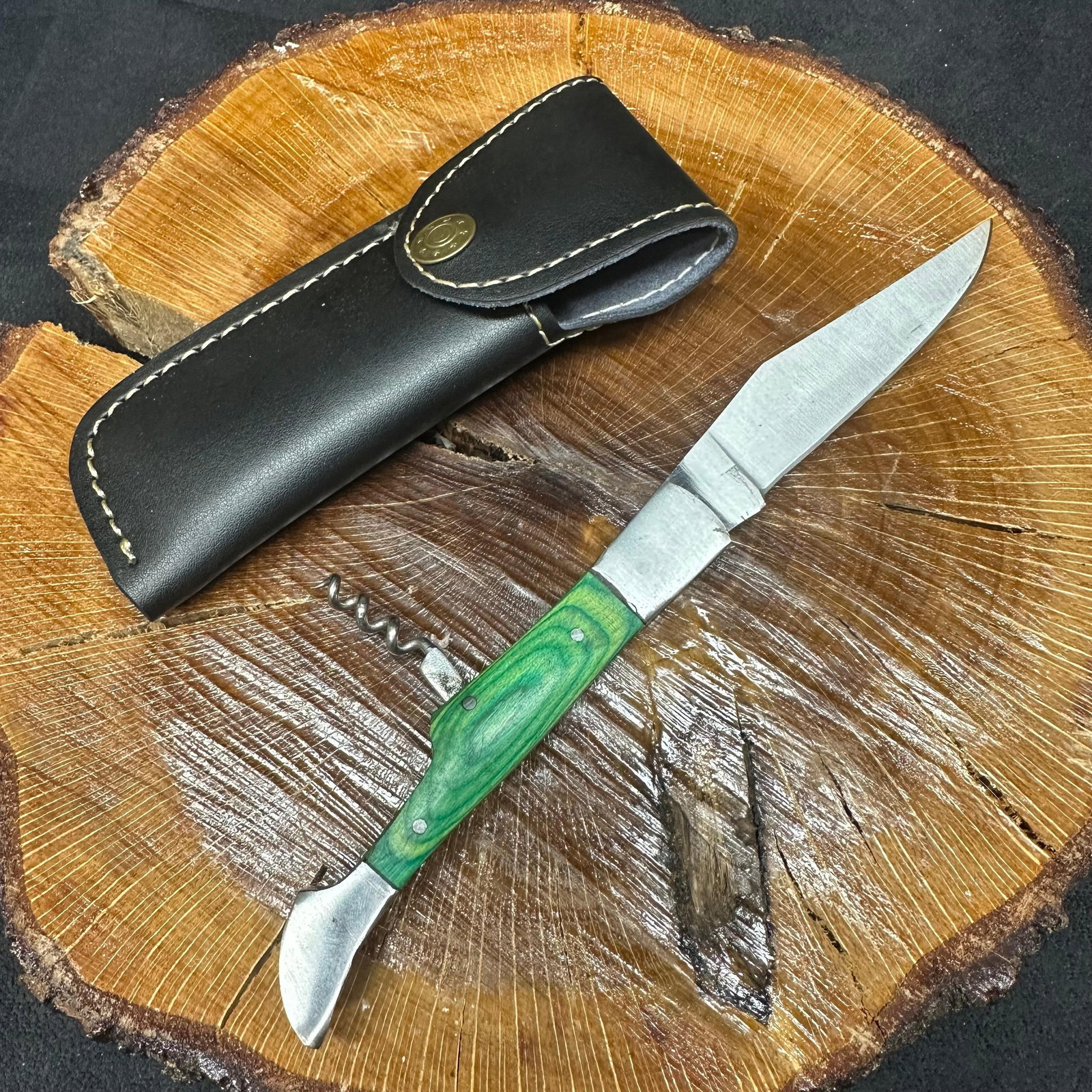 Folding Blade Pocket Knife MHS Cutlery Green Handle R29: Folding small blade pocket knife by MHS Cutlery featuring a steel blade, corkscrew, and decorative spine work. The handle has a contoured, wood/epoxy resin-style grip with metal mosaic accents. Includ