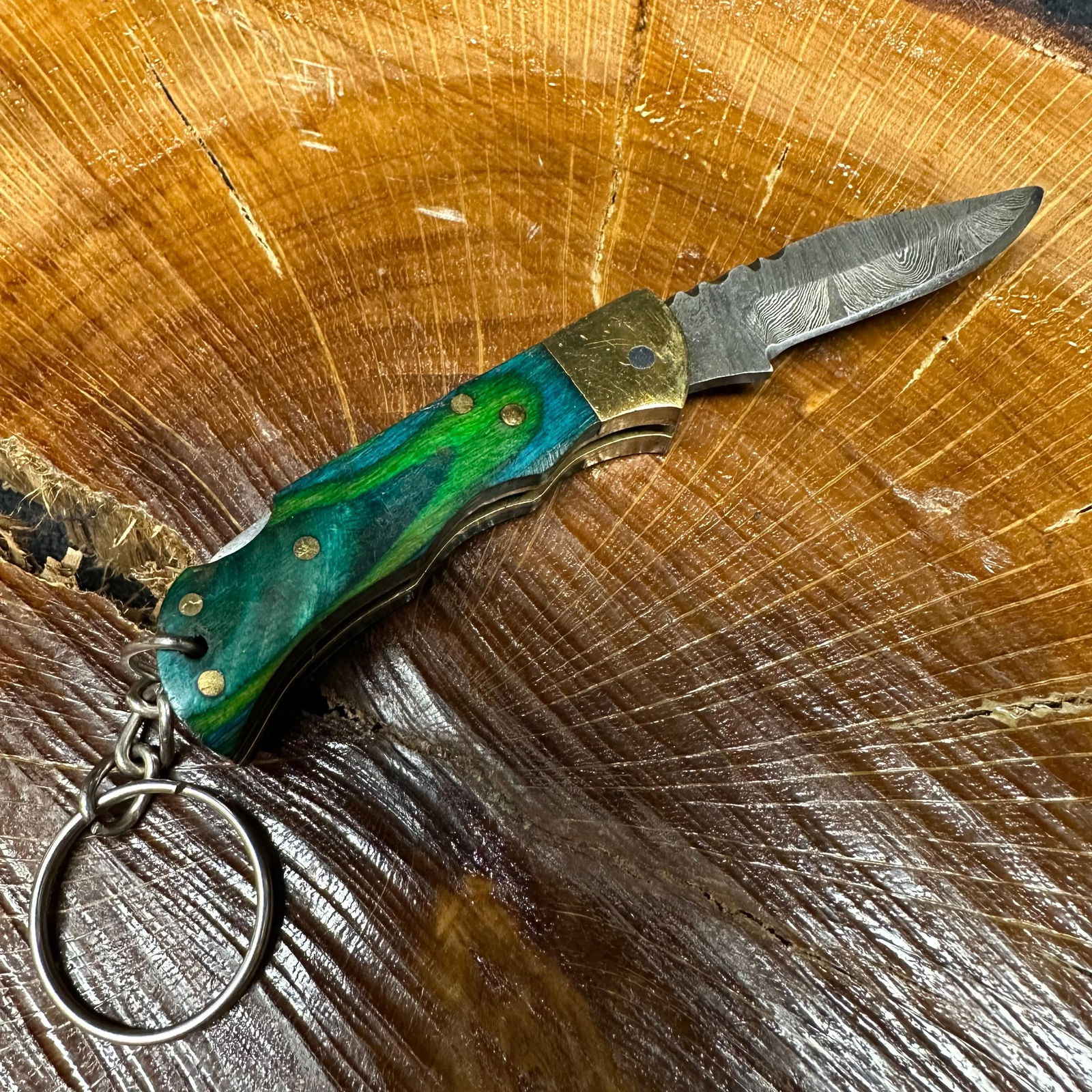 MHS Cutlery Keychain Steel Folding Blade Pocket Knife R52: Small folding-blade pocket knife featuring a steel blade and a compact epoxy-resin/wood handle secured with brass pins. Includes an attached metal key ring for easy carry. Good like-new condition wit
