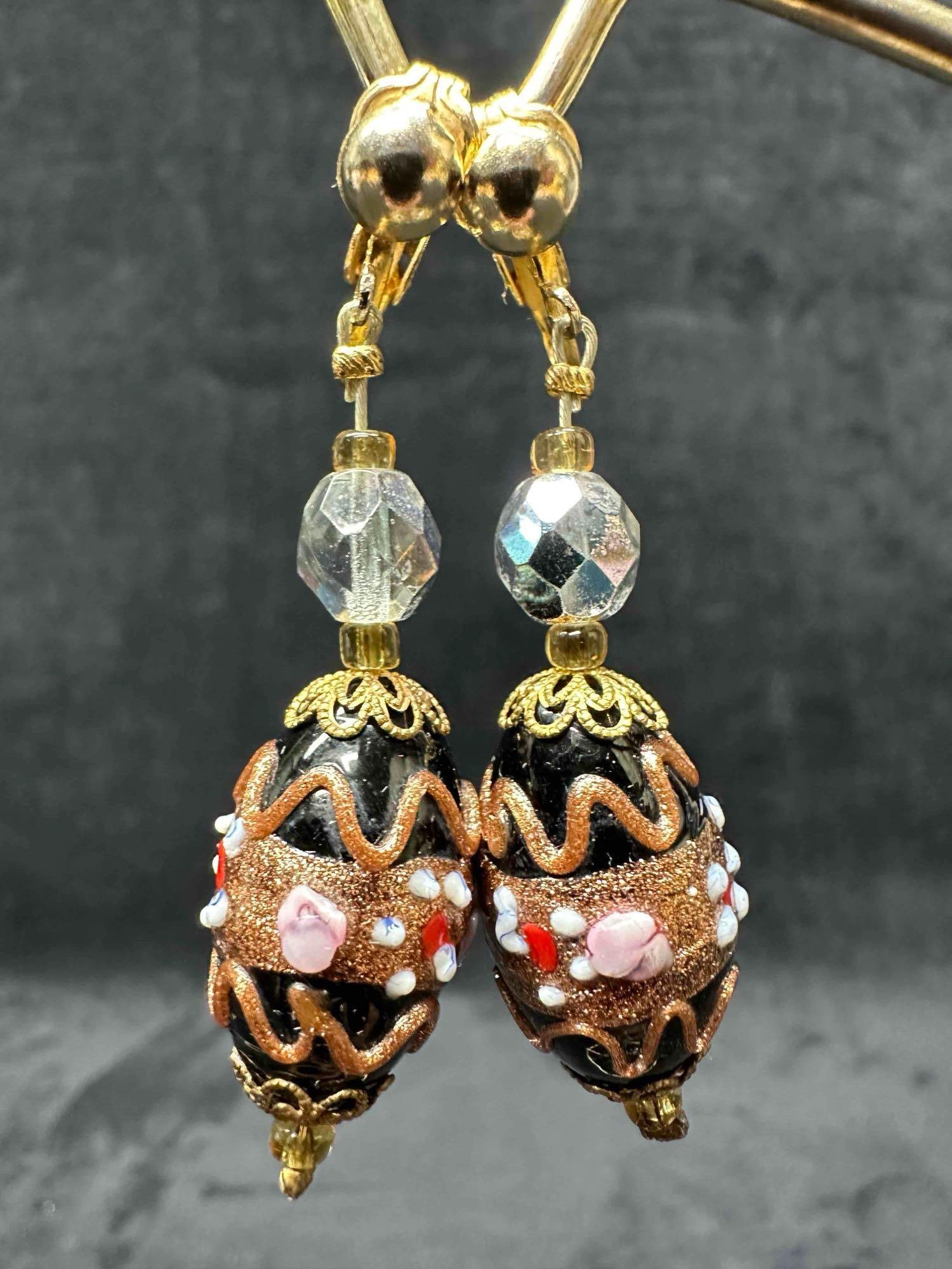 Murano Venetian Art Glass Lamp Work Black Floral Copper Dangle Drop Earrings G60: Murano Venetian Art Glass Lamp Work Black Floral Copper Dangle Drop Earrings G60. Earrings with black glass beads with beautiful designs on each. The earrings feature a paddle back clip on clasp closu