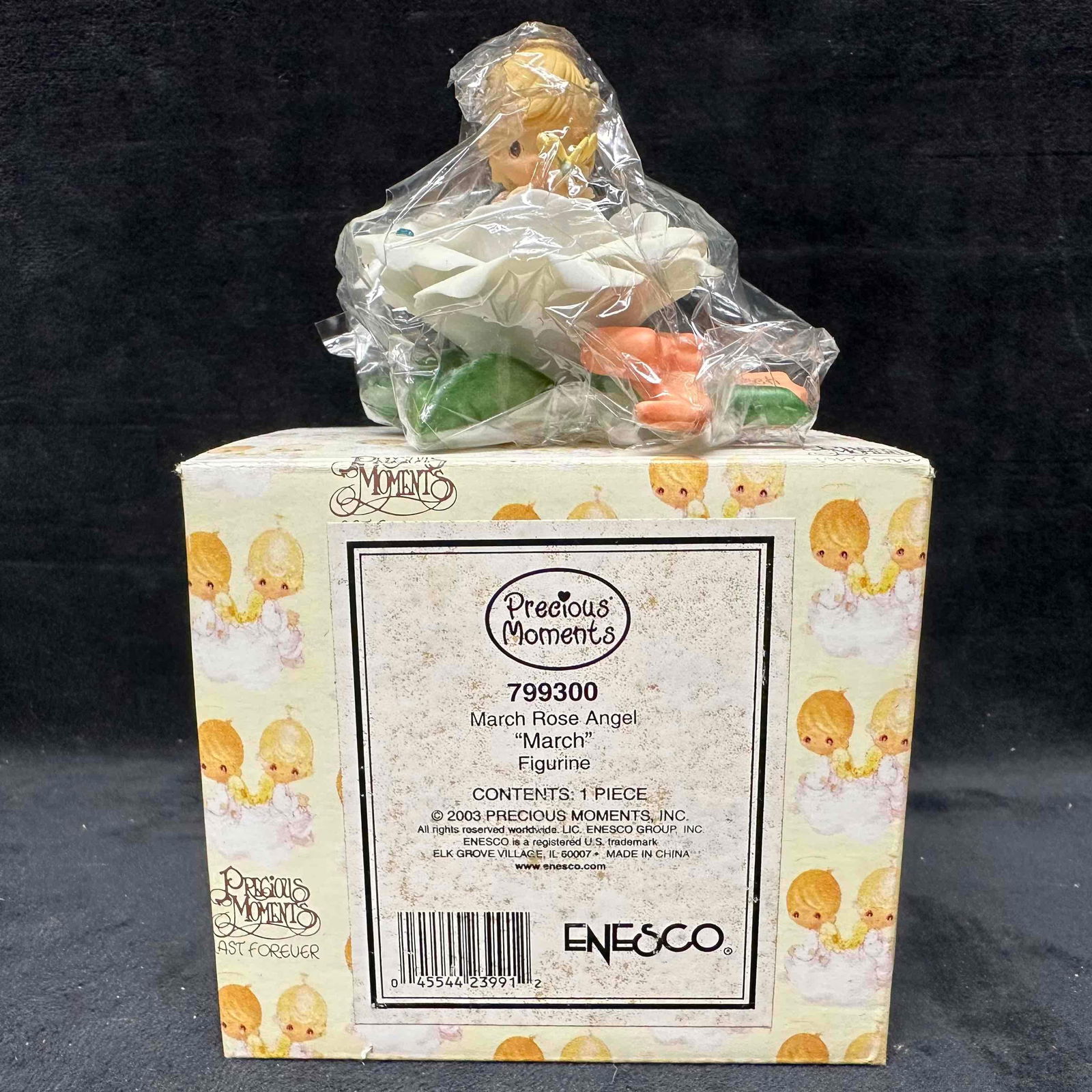 Precious Moments March Rose Angel Figurine 799300: Precious Moments “March Rose Angel” figurine, model 799300, by Enesco. Dated 2003, this collectible features a sweet angel sitting inside a rose with butterfly detail. The figurine comes with