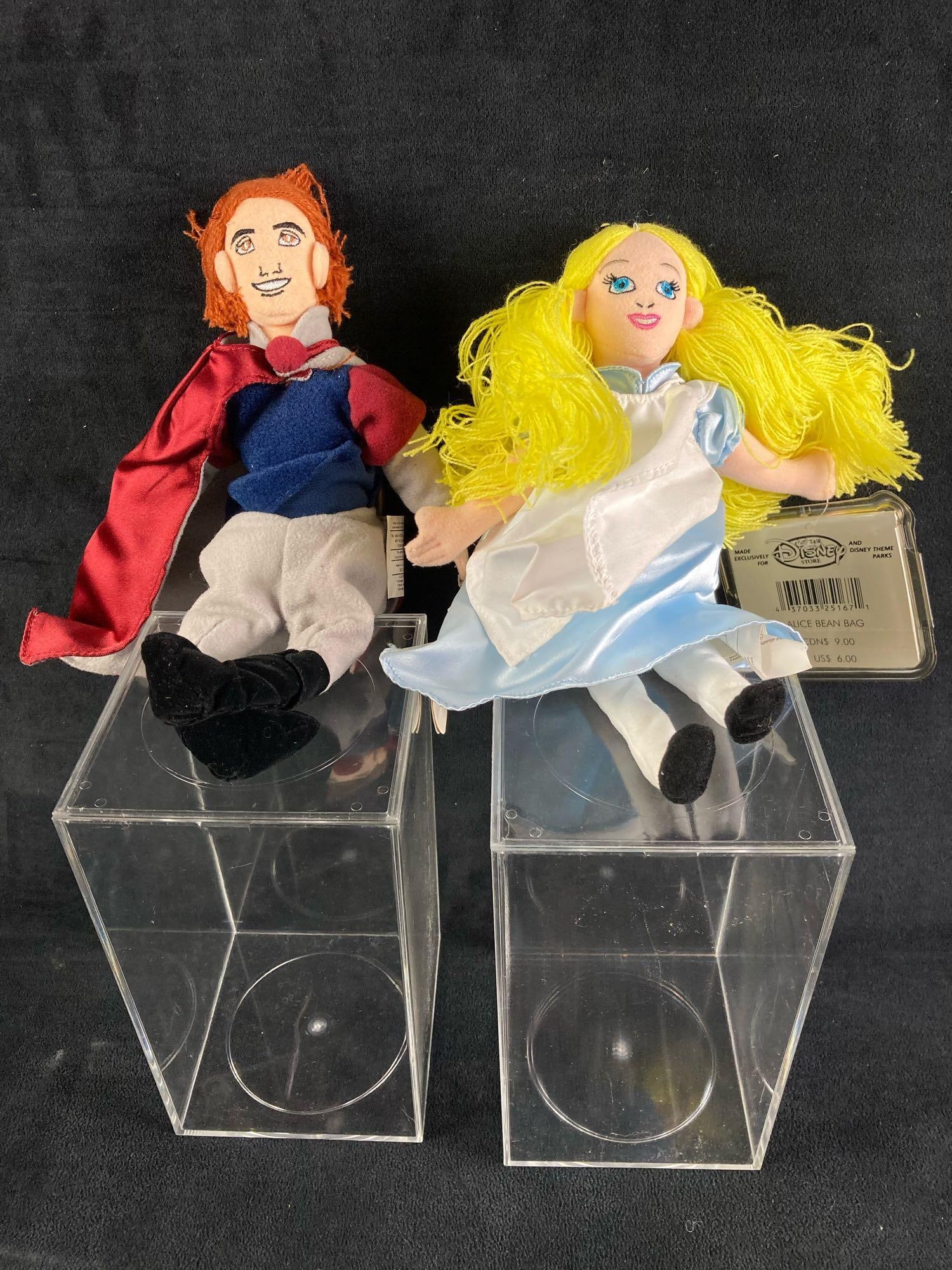 Set of (2) Disney Plush Bean Bag Dolls Alice and Prince Phillip: This auction features a set of (2) Disney plush bean bag dolls in particular Alice from Alice in Wonderland and Prince Phillip from Sleeping Beauty. They were found in a large collection of Disney ite