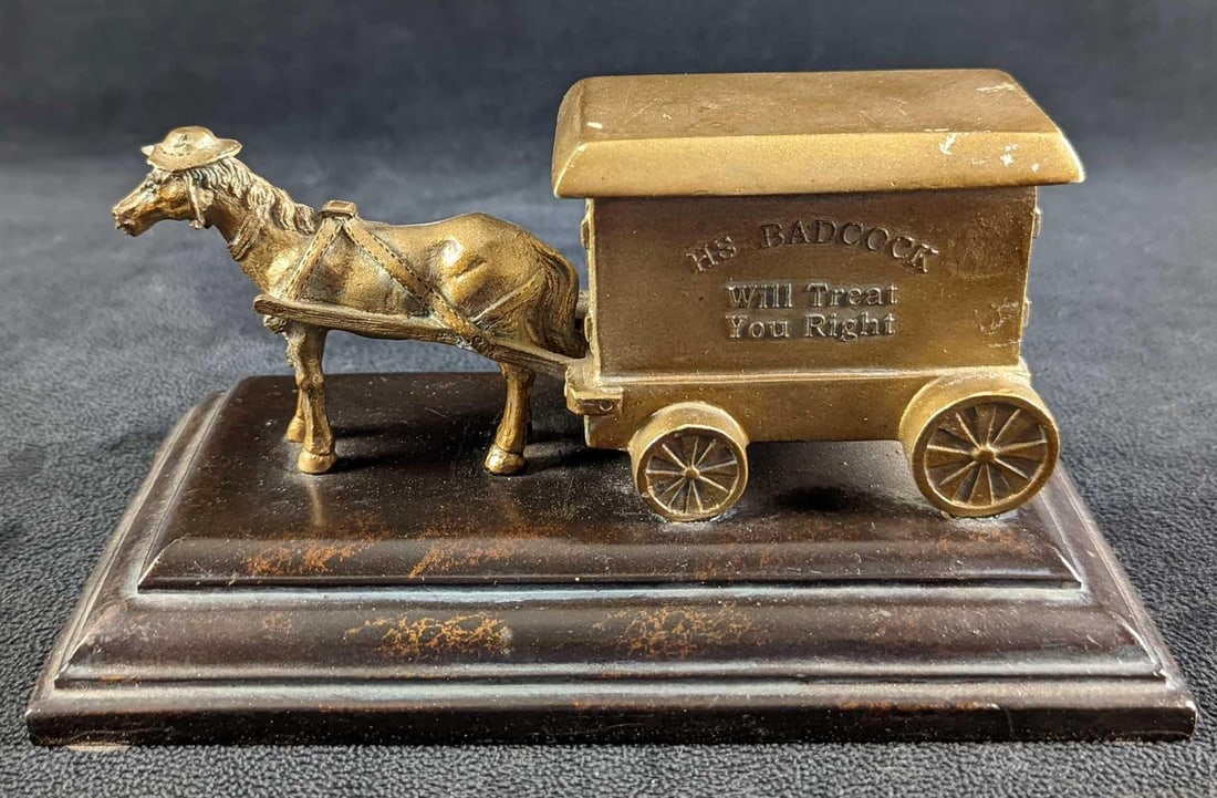 Badcock Furniture 100th Anniversary Horse-Drawn Delivery Cart: Details: This figurine is part of a commemorative collection from Badcock featuring all their delivery trucks for the last 100 years. This was the first one used, a horse-drawn cart (or wagon) used