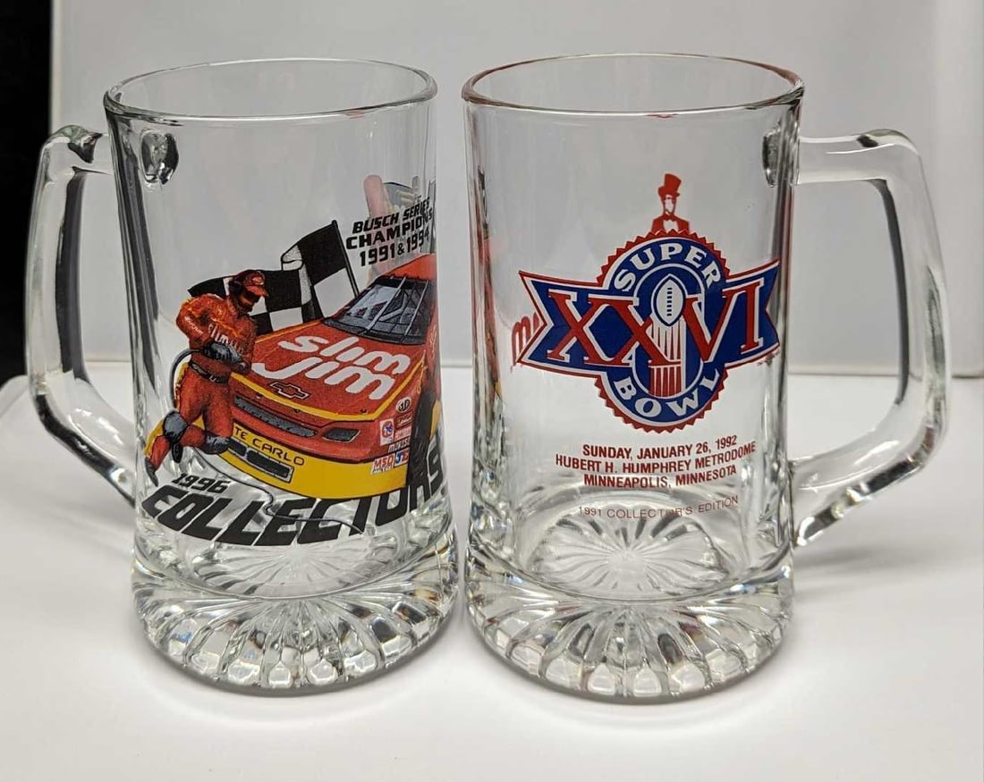 2 Large Glass Slim Jim Super Bowl & Busch Series Mugs: 2 Large Glass Slim Jim Super Bowl & Busch Series Mugs. Each mug is approx 5 1/2" x 3 3/4" x 6 5/8'" and together they weigh 4.60lbs. One mug has a graphic for Super Bowl XXVI (1992) and the other has