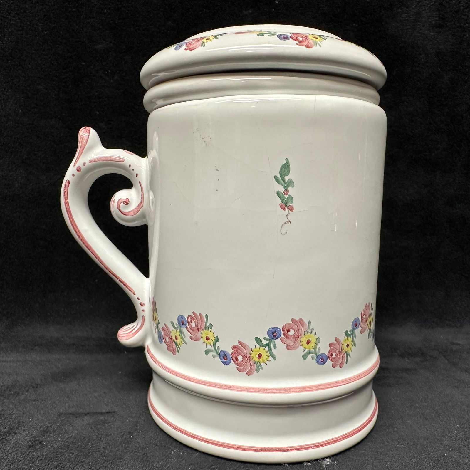 Floral Ceramic Lidded Mug with Insert Strainer: White ceramic lidded mug featuring a hand-painted floral border and decorative scroll handle. Includes matching inner strainer/insert and lid. Marked on the bottom base. This item is in pre-owned, pre