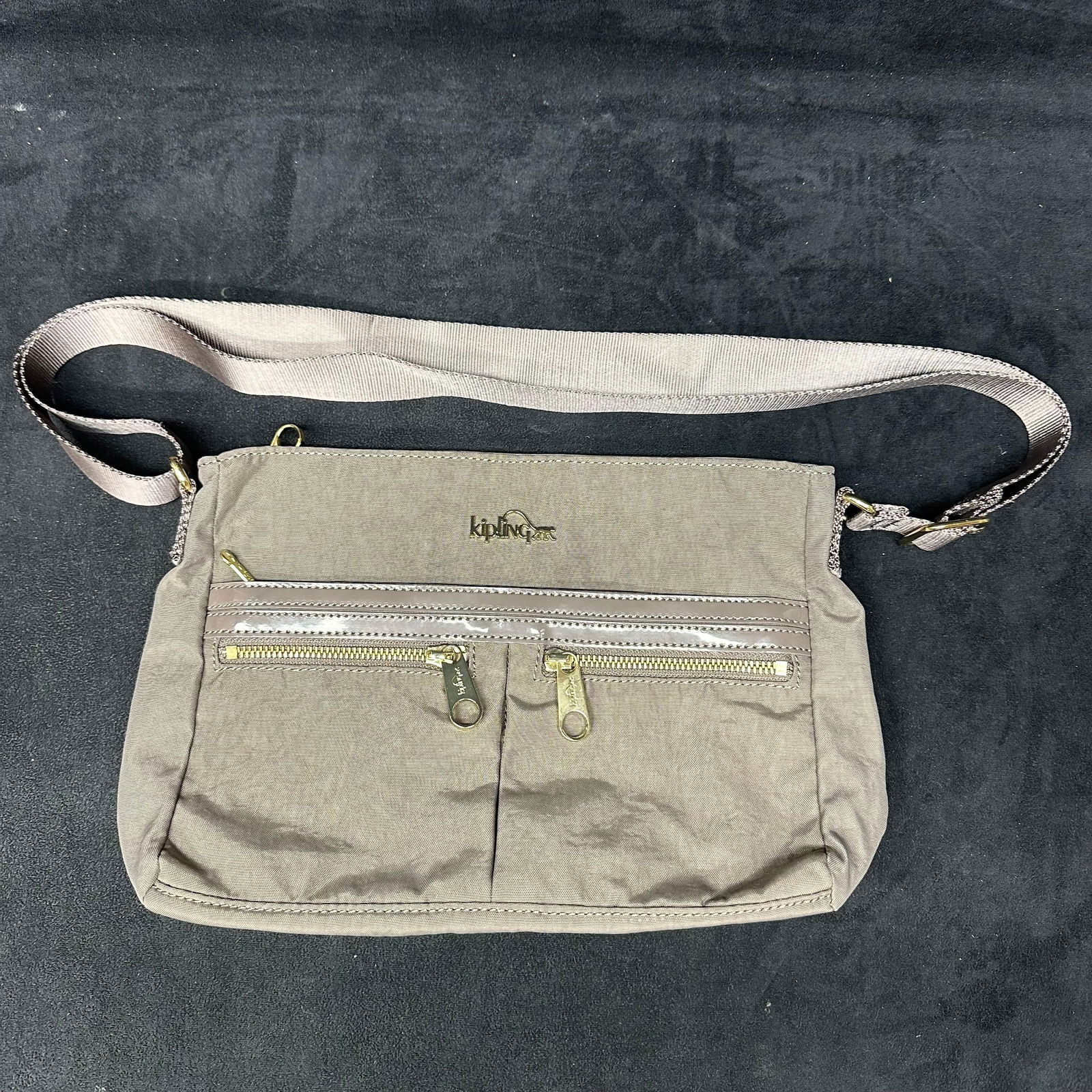 Kipling Nylon Crossbody Shoulder Bag Light Gray: Kipling nylon crossbody shoulder bag featuring a solid gray color. Includes an adjustable fabric shoulder strap, zip-top closure, exterior zip pocket, and interior zip pocket with light-colored lining