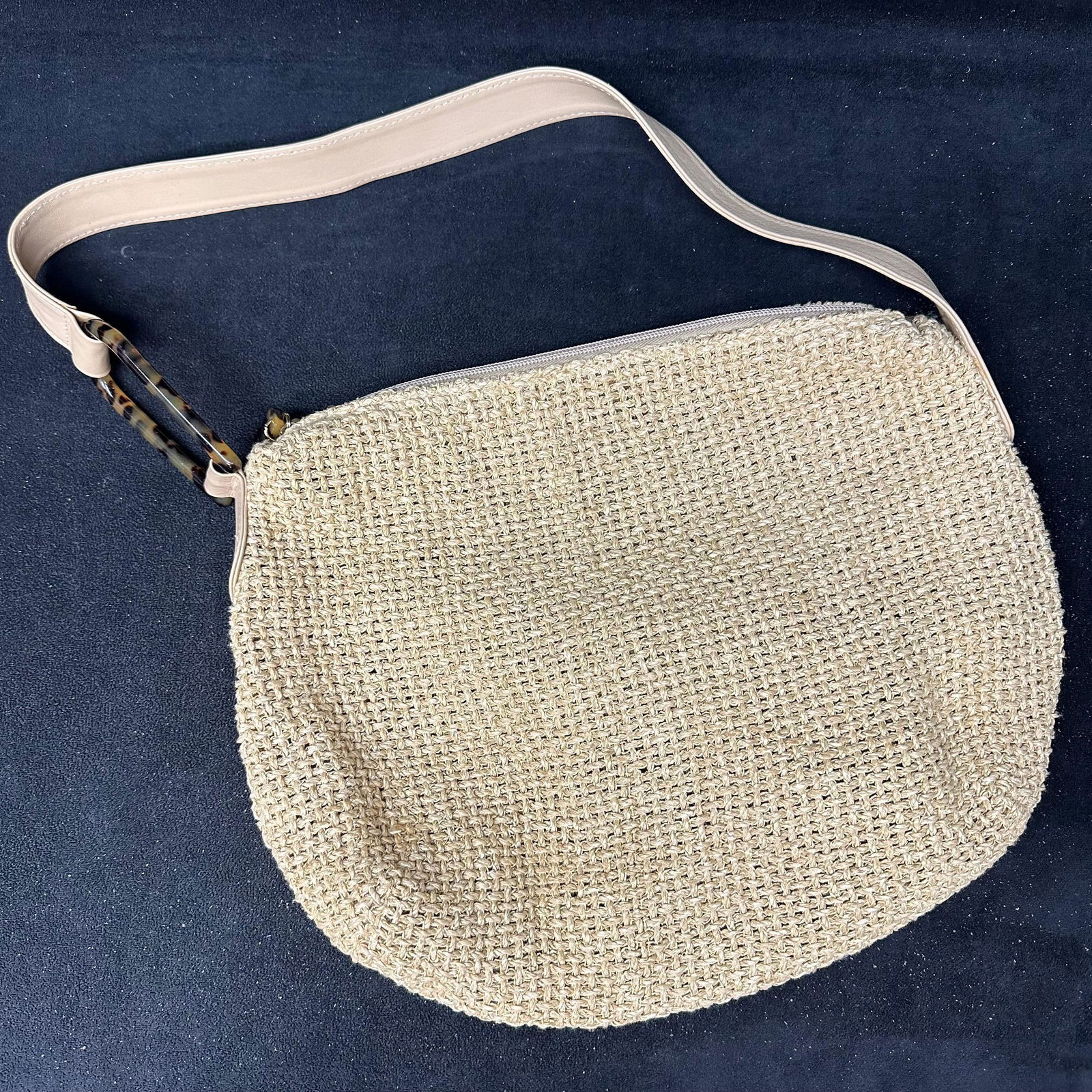 Adrienne Vittadini Woven Straw Shoulder Bag with Leather Strap: Adrienne Vittadini woven straw shoulder bag in a neutral tan color. Features a zip-top closure, fabric-lined interior with an interior zip pocket, and light tan leather shoulder strap with