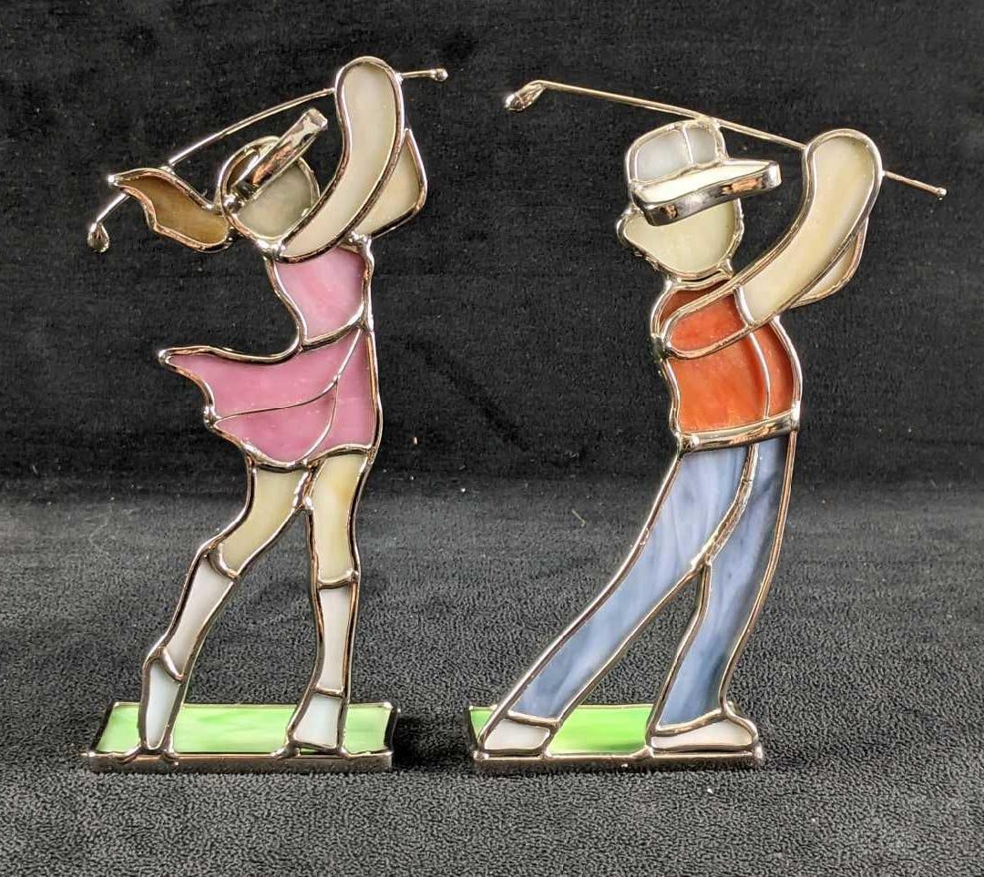 Stained Glass Like Golfer Man and Woman Bookends: Stained Glass-Like Golfer Man and Woman Bookends This is a set of bookends that is made to look like stained glass golfers. The design is beautiful it is made from resin. These bookends have no known