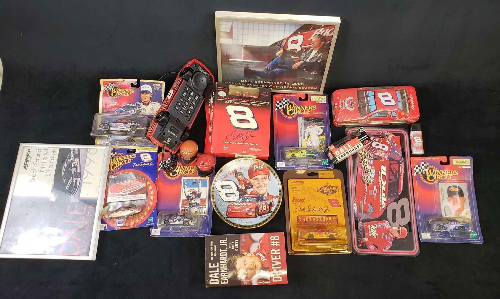 Collection of 18 Dale Earnhardt Jr Memorabilia Items: Collection of 18 Dale Earnhardt Jr Memorabilia Items. This set of Dale Earnhardt memorabilia items is in good used condition. Several items are still in the original packaging. The items and condition