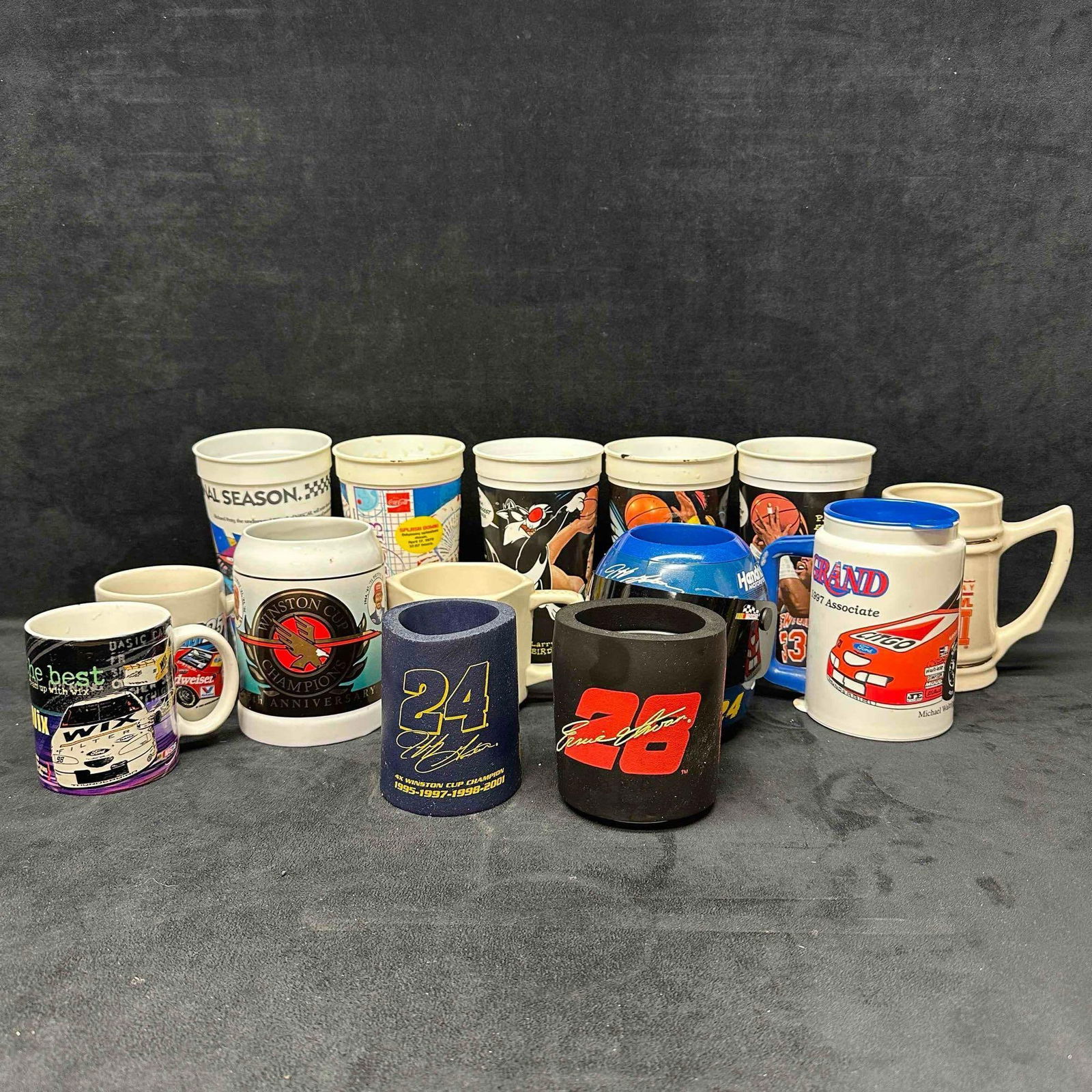 NASCAR Basketball Football Mug Cup Koozie Set Jeff Gordon Helmet: Several sport souvenir included in this set from mug, can holder, and other cups. NASCAR, NBA, NFL, and movie entertainment souvenirs. Several NASCAR driver's represented such as Jeff Gordon. Thes